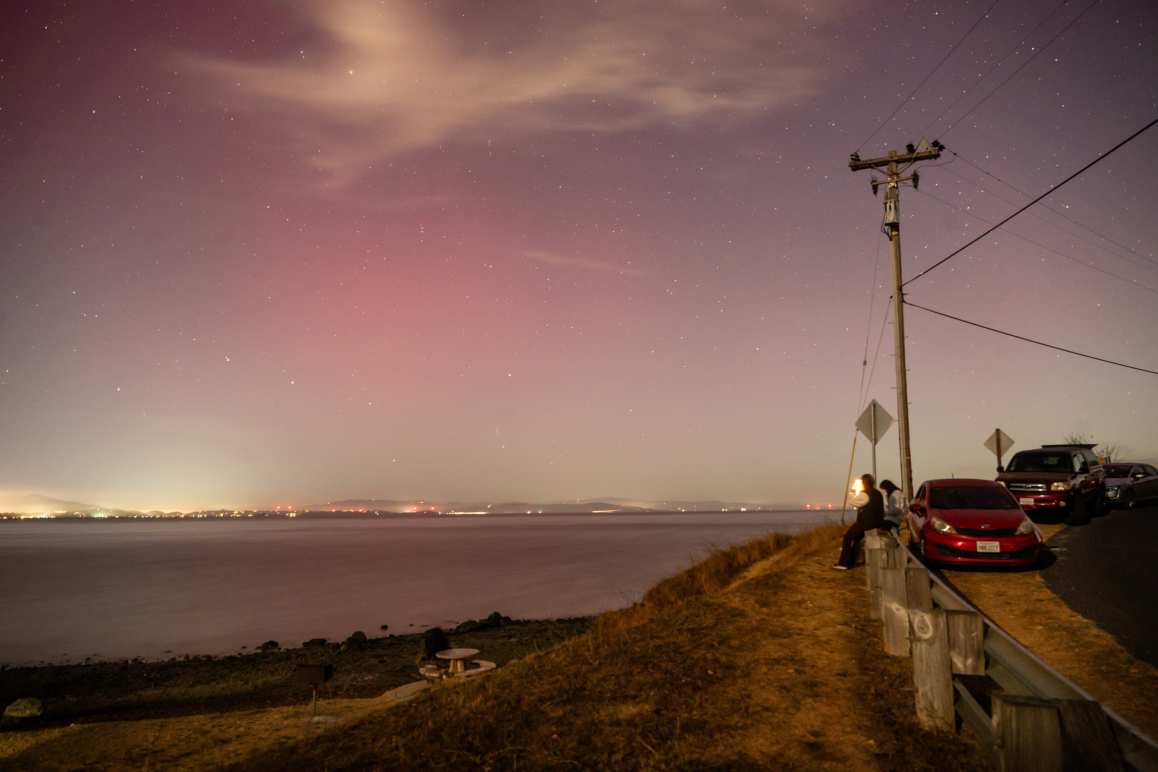 Visitors to China Camp State Park watch the northern lights glow over Marin County.