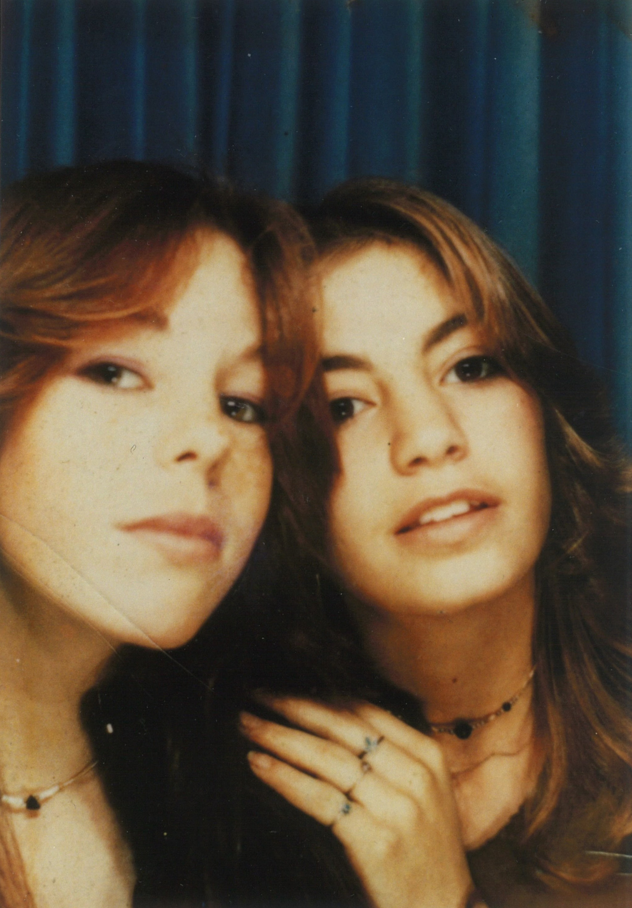 Two teenage girls pose for a photo.