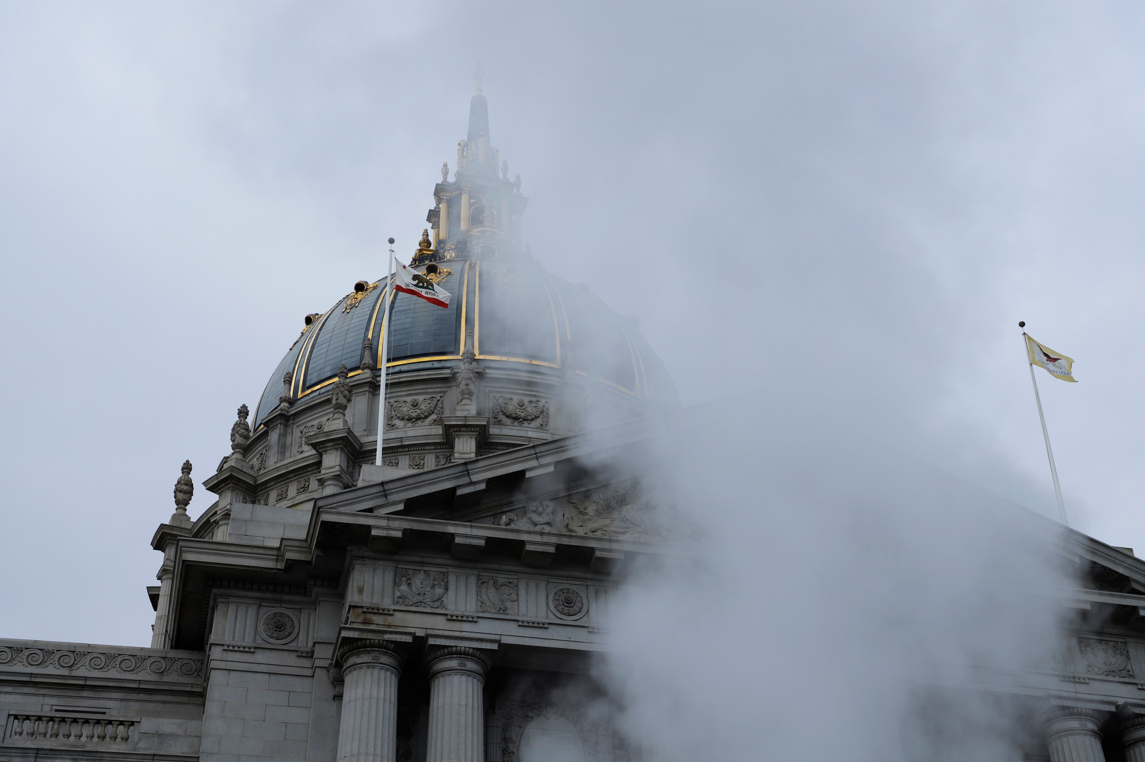 City Hall's dome on a cloudy day with steam rising in the foreground.