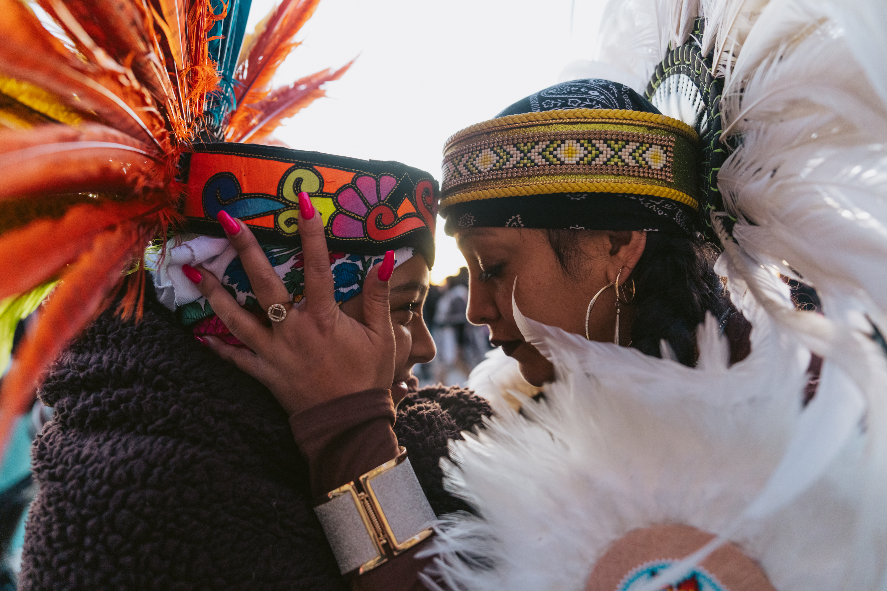 Julia Arroyo (right) and daughter Guillermina share a moment before their performance with the Mexica dance group during the Sunrise Ceremony on Alcatraz Island.