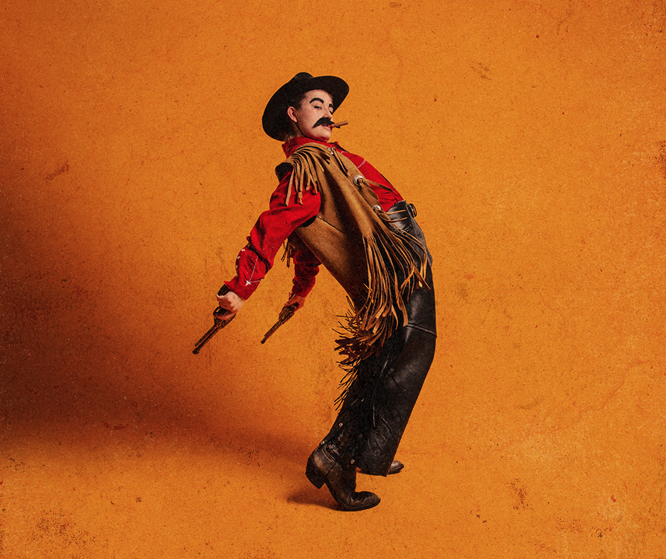 A person dressed as a cowboy leans backward dramatically. They wear a hat, a red shirt, fringed vest, and chaps, holding a cigar and toy guns on a yellow background.