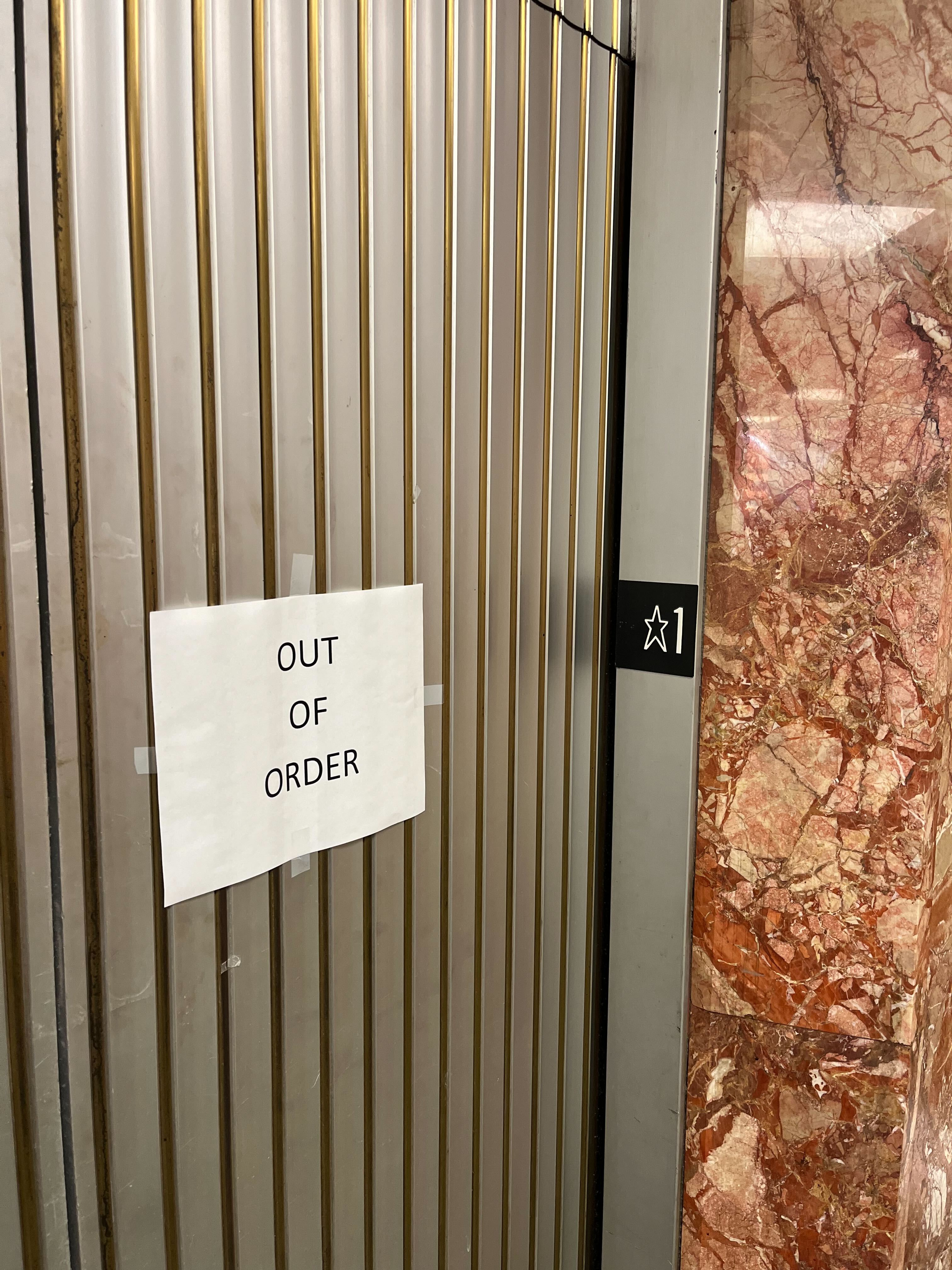 An elevator with an &quot;out of order&quot; sign in the Hall of Justice.