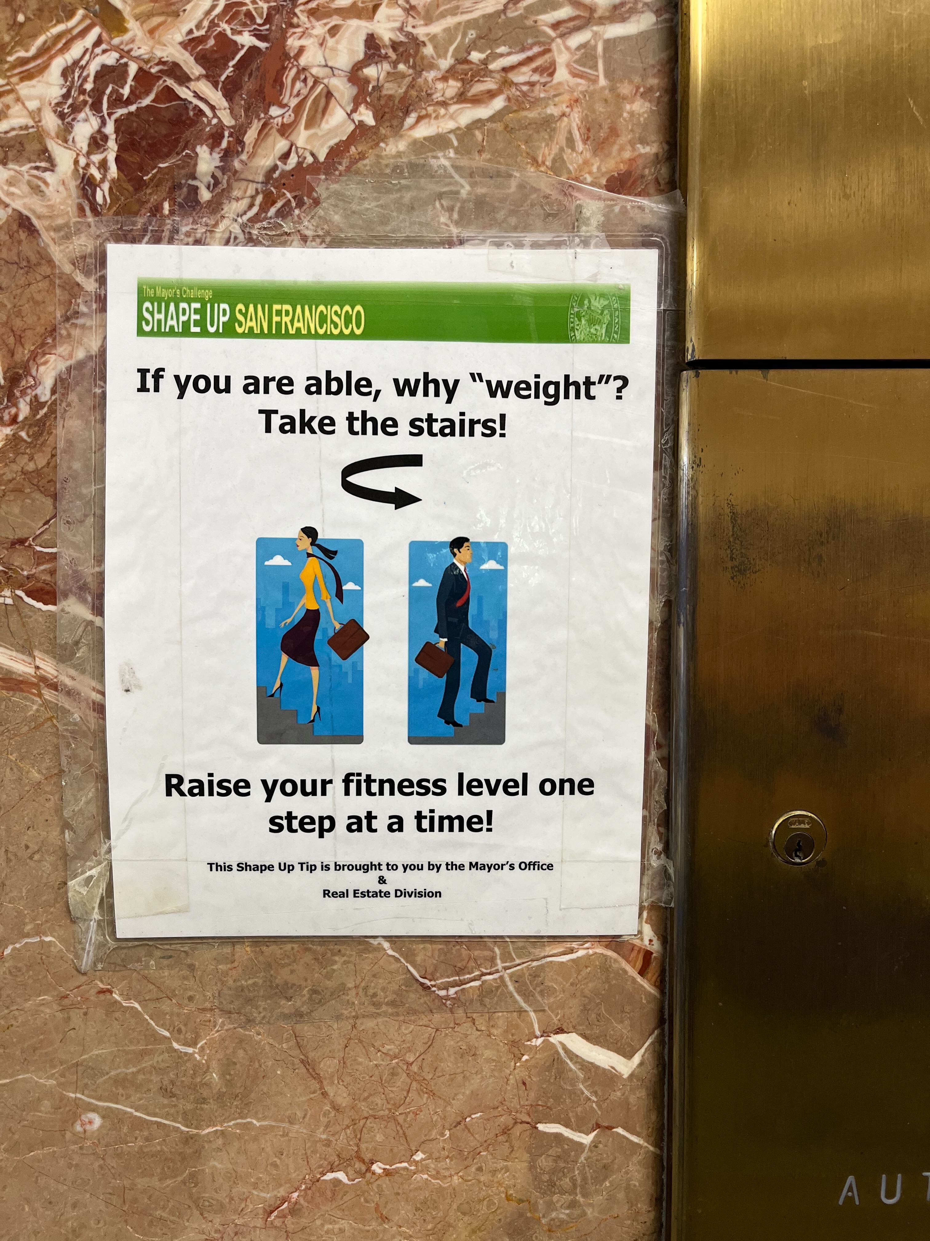 A sign next to the elevator in the Hall of Justice encourages visitors to &quot;shape up&quot; by taking the stairs.