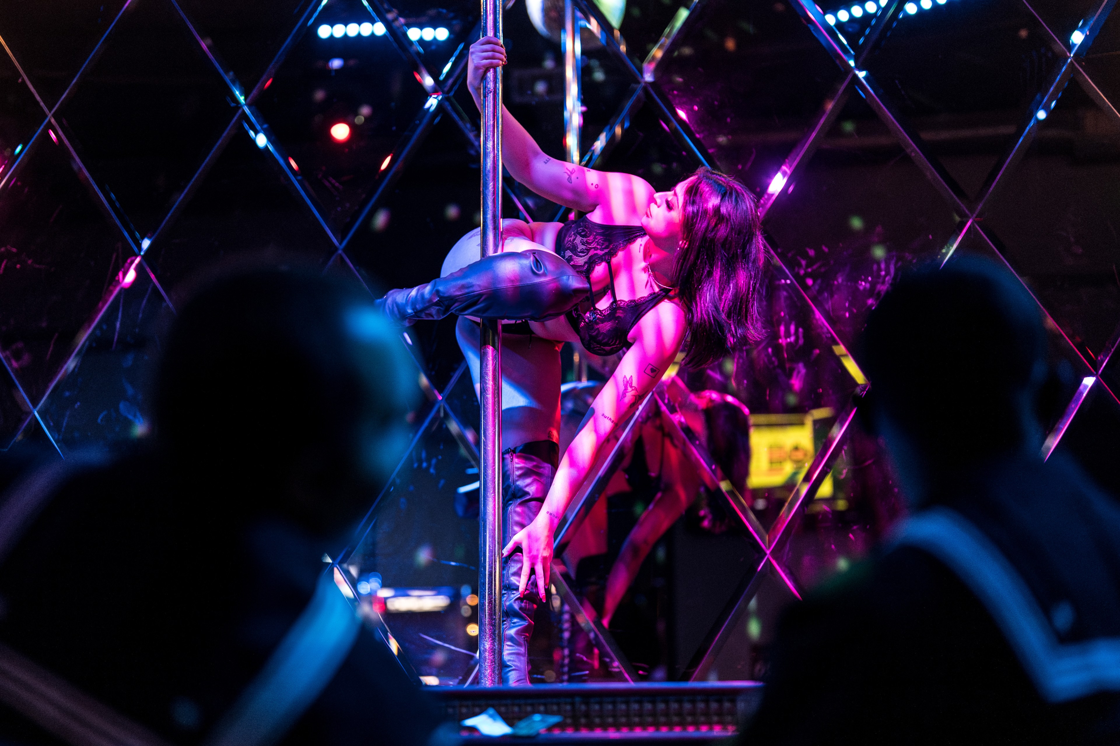 U.S. Navy sailors watch as a dancer who goes by the stage name “Dallas” performs on the main stage at Condor Club in San Francisco on Thursday, Oct. 10, 2024. According to rumors, it seems that the popular hangouts for sailors during fleet week are at the  strip clubs.