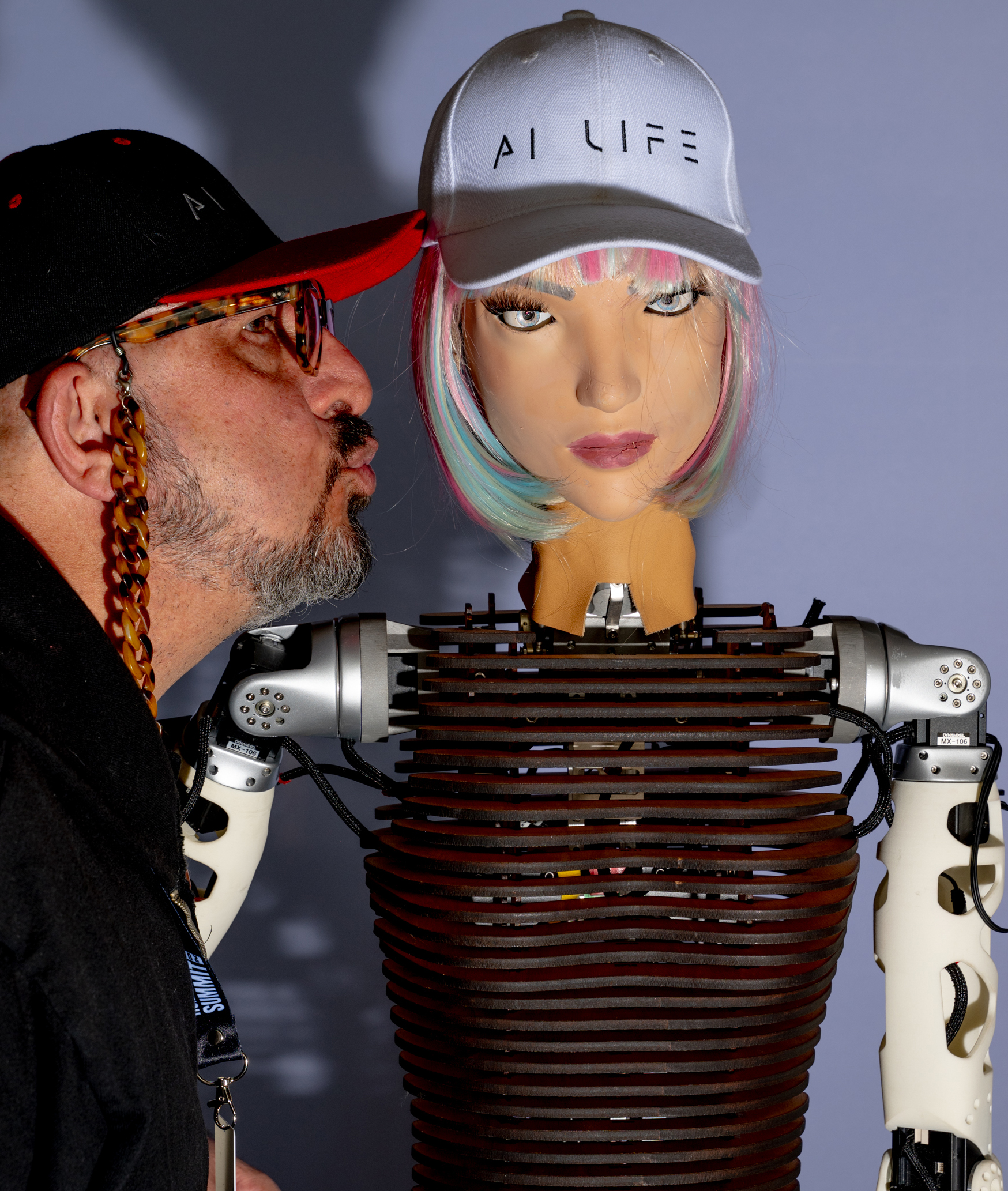 Anoush Sadgeh, CEO of AI Life Kisses Xoie the Robot, of  AI Life Humanoid Robots at the Computer Museum in Mountain View, CA on Wednesday, December 11, 2024.