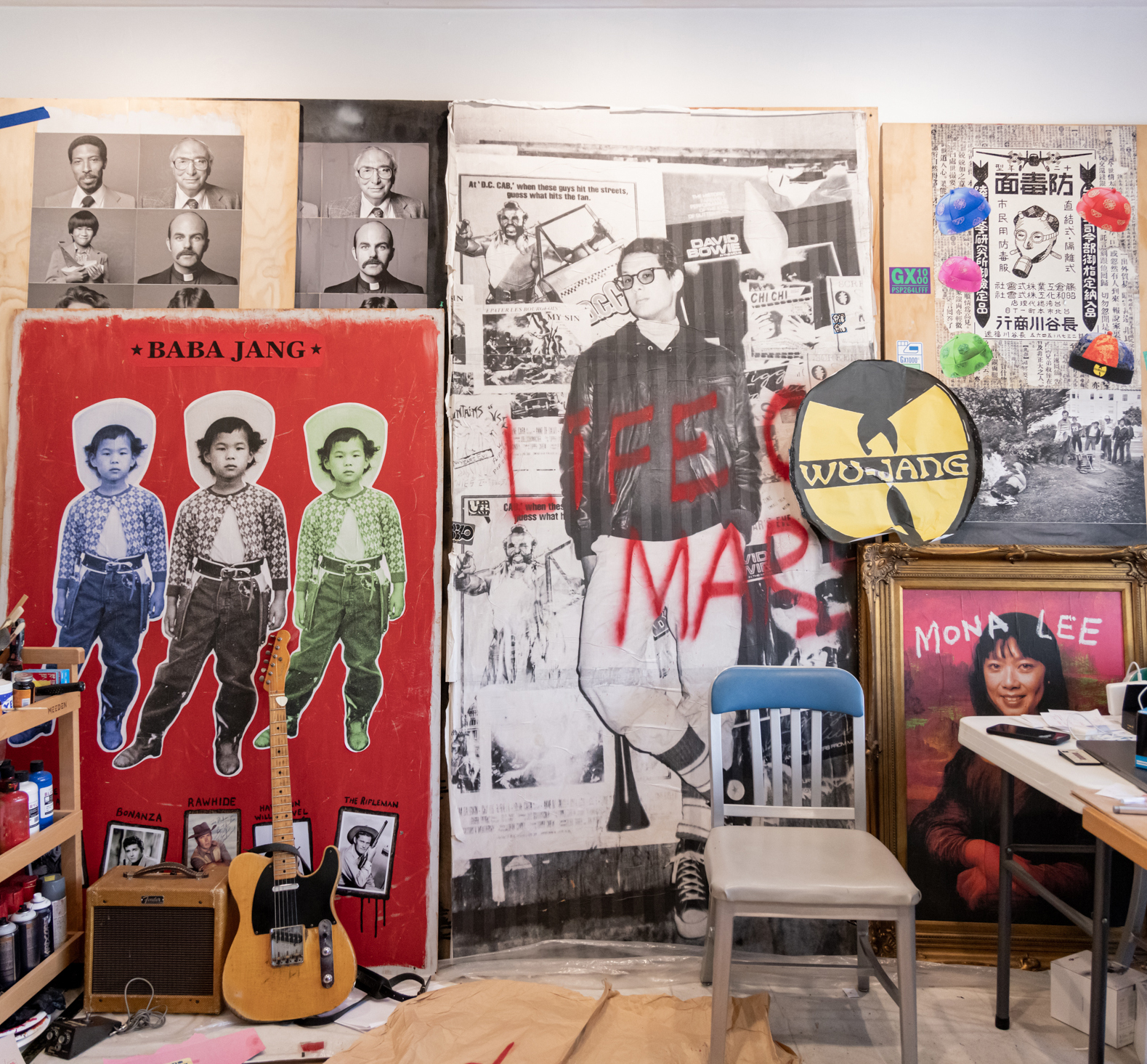 The image shows a creative workspace with posters of various black-and-white and color portraits, a guitar, paint supplies, and a framed picture labeled &quot;Mona Lee.&quot;