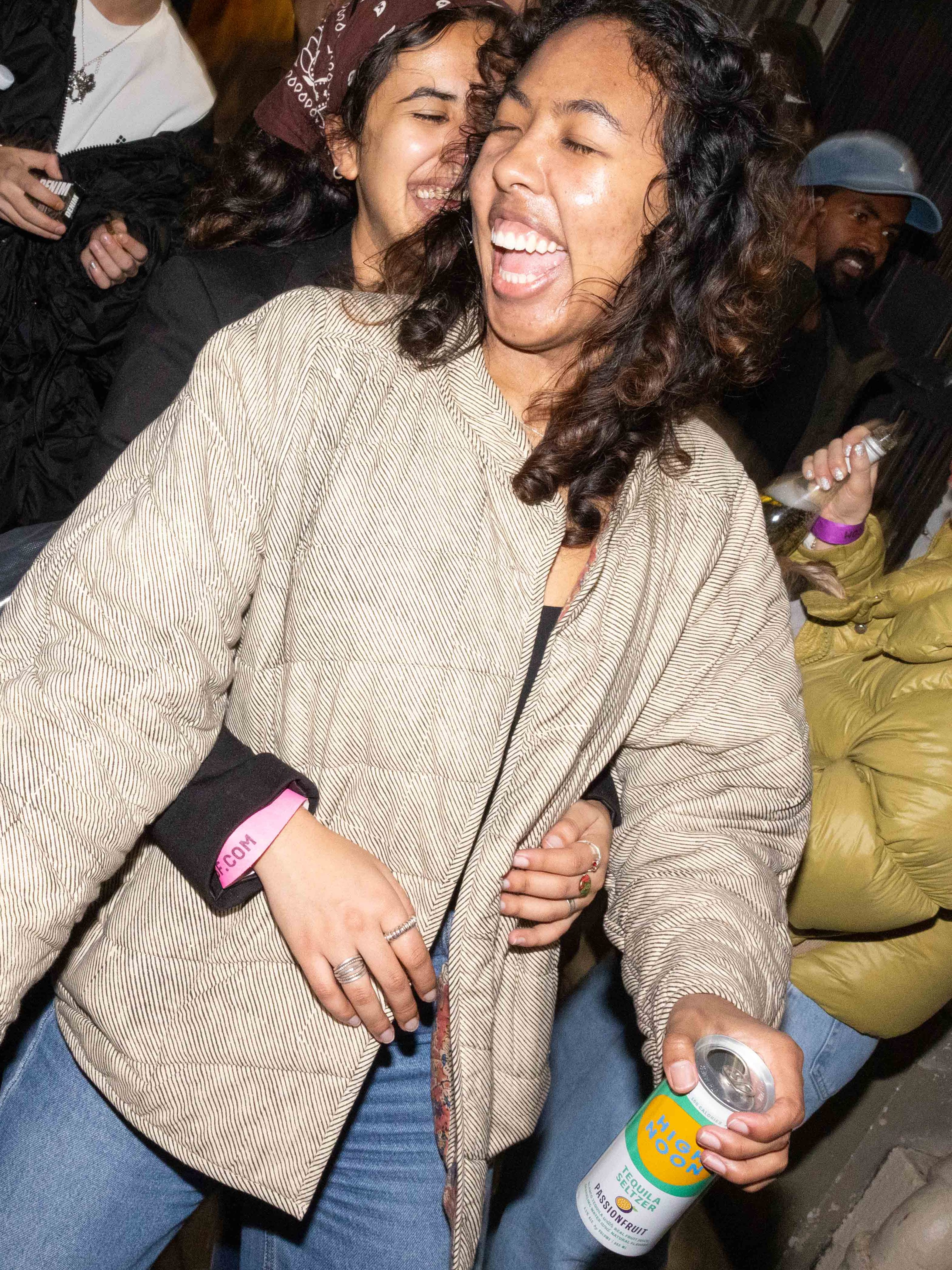 Two attendees dance together