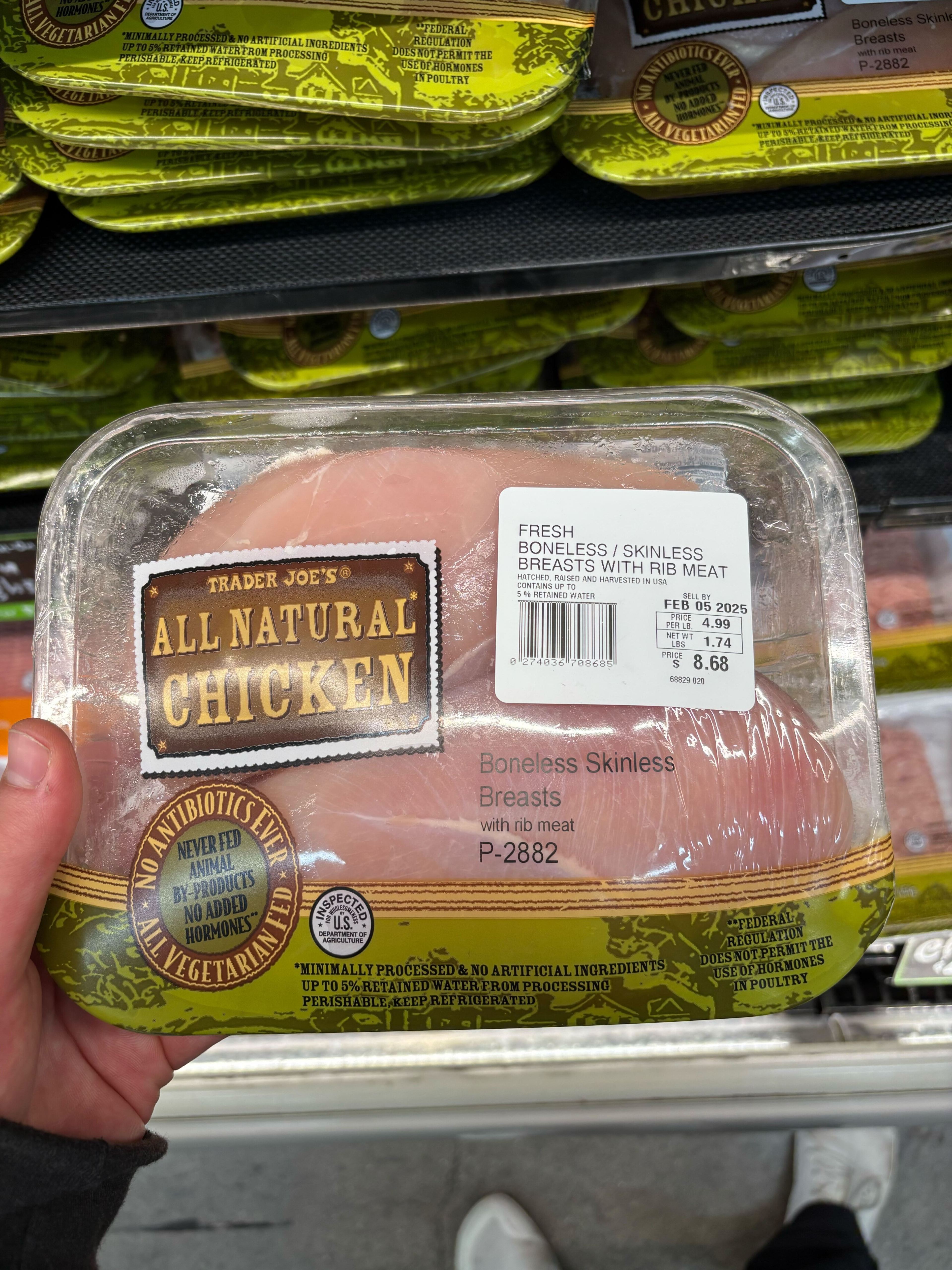 The image shows a package of Trader Joe's boneless, skinless chicken breasts with rib meat. It is marked as all-natural, with no antibiotics or hormones.