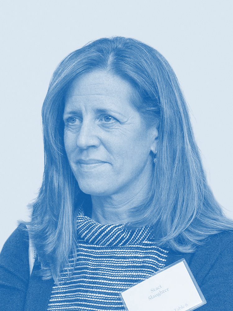 The image shows a woman with long hair wearing a striped top and a name tag. The photo is in a monochrome blue tone.