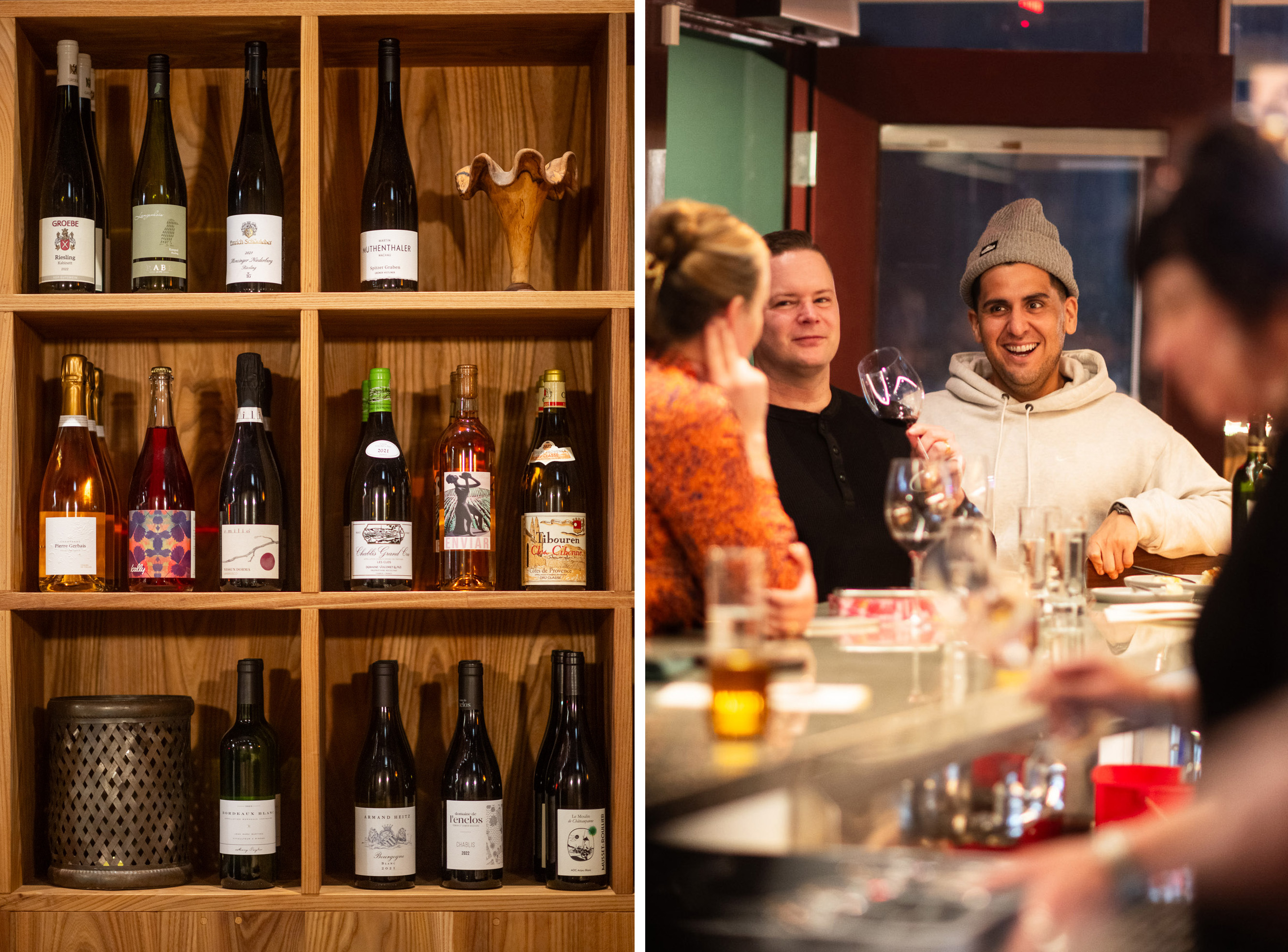 The image shows a shelf of various wine bottles on the left. On the right, people at a bar are enjoying drinks, with one person holding a wine glass, smiling.