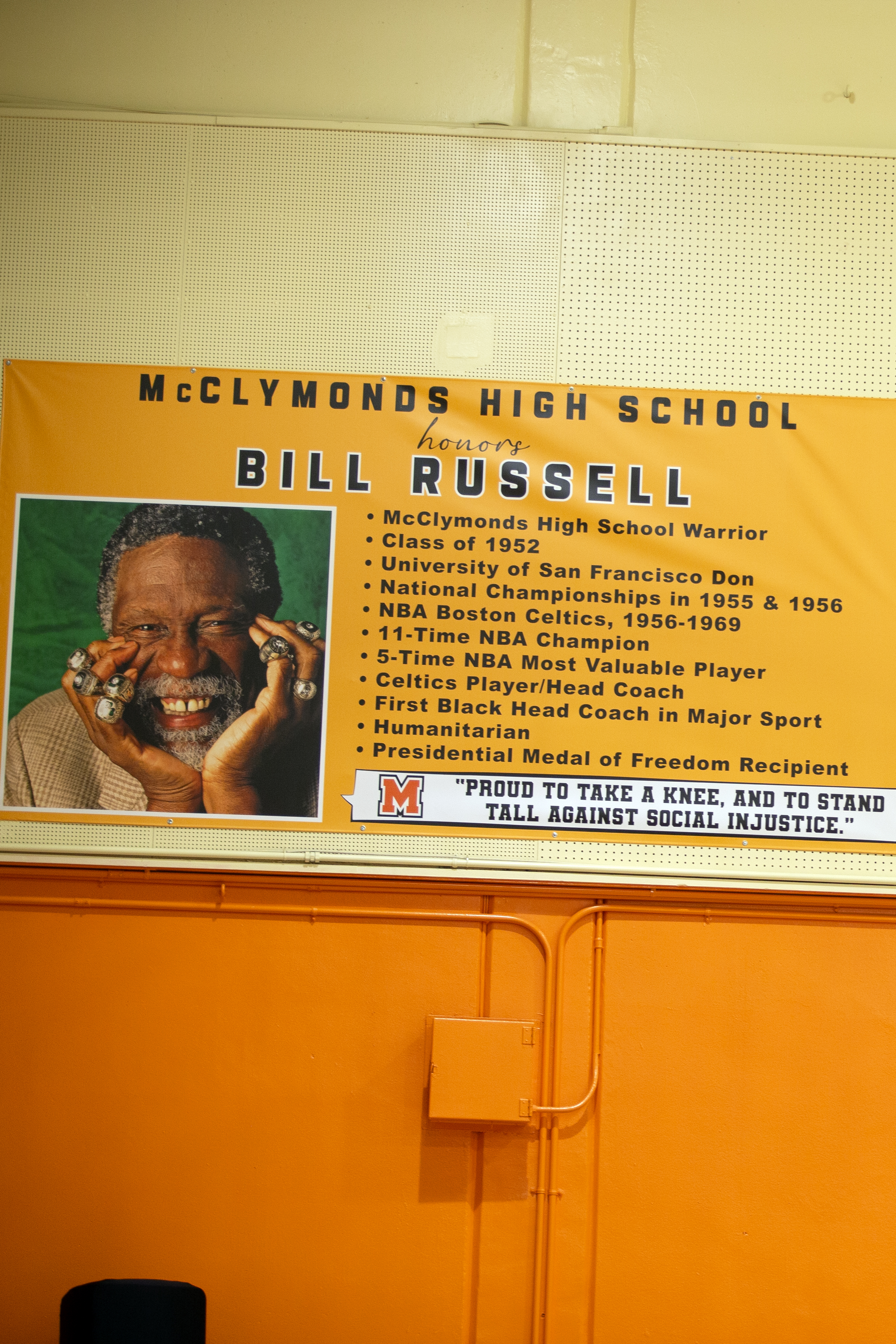 A banner honoring Bill Russell is displayed, featuring his accomplishments and a quote against social injustice. It has a photo of him with championship rings.