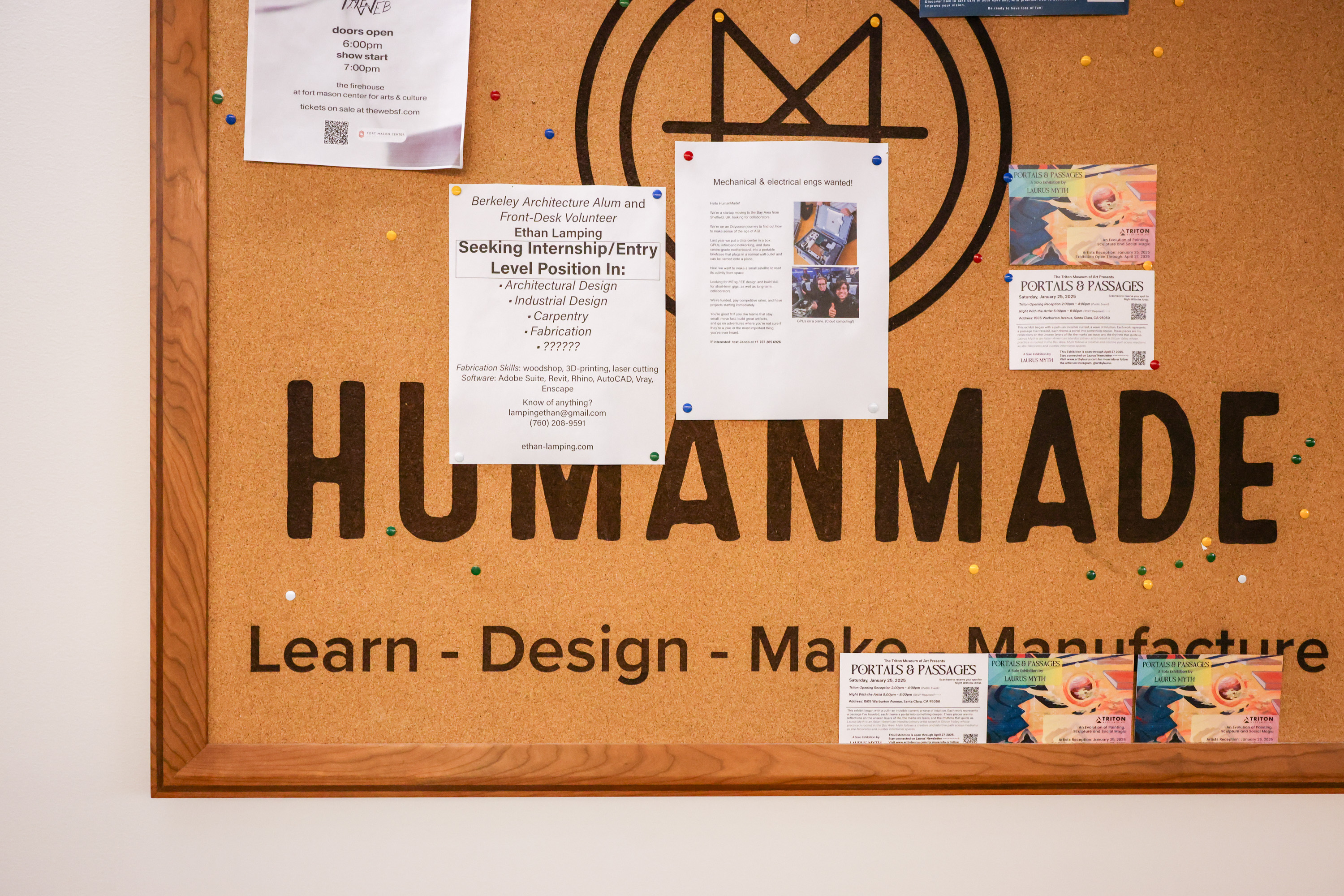 Job postings on white and colored paper are hung on a tan cork board at Humanmade.