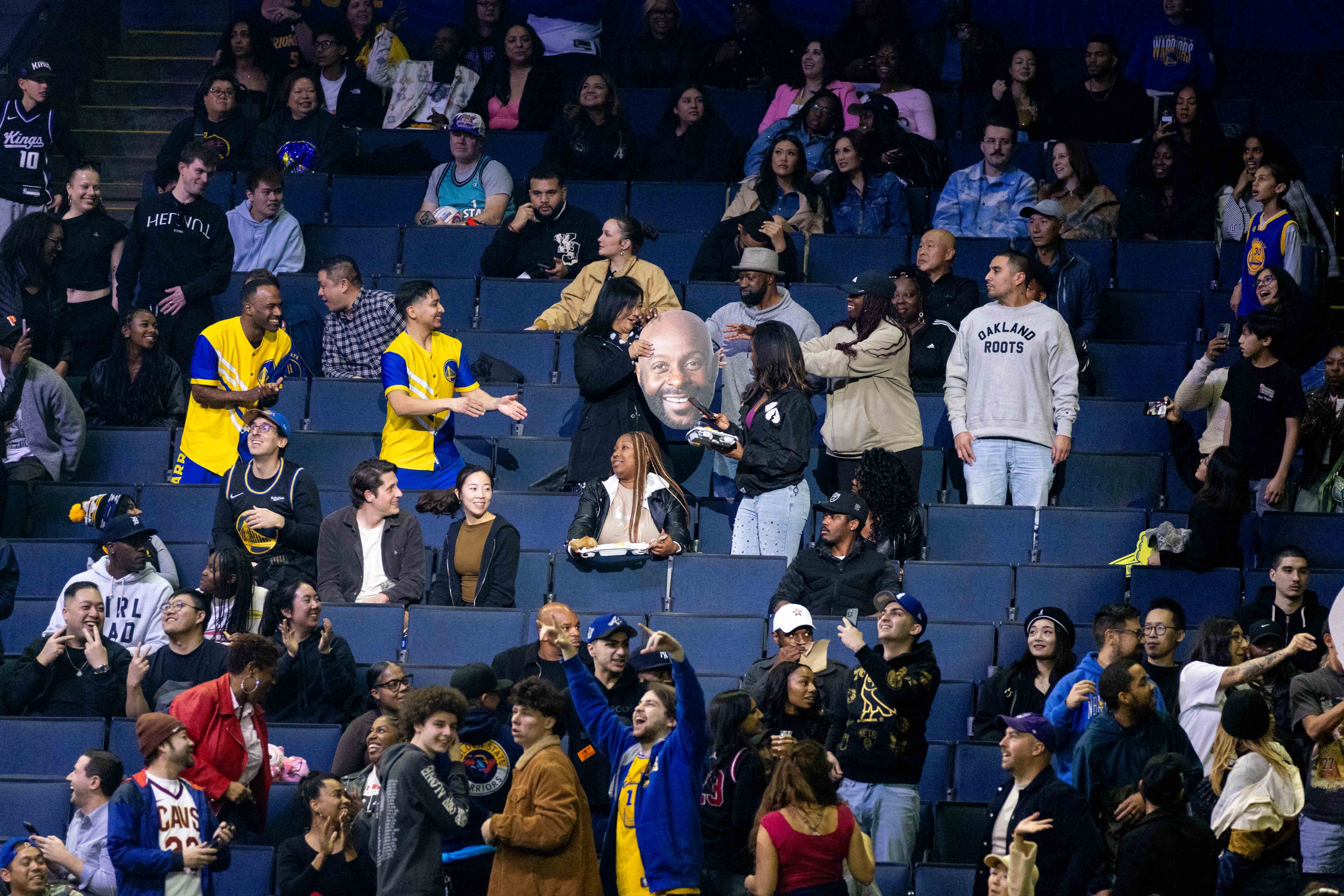 People participate in a game where a large head cut out is passed around during the celebrity All-Star Weekend game at Oakland Arena in Oakland on Friday, Feb. 14, 2025. Noah Kahan and Kai Cenat are some of the biggest names on Team Bonds, along with assistant coach 2 Chainz. Bonds also has some athletic talent with a former NBA player in Baron Davis and a two-time WNBA All-Star in Allisha Gray.