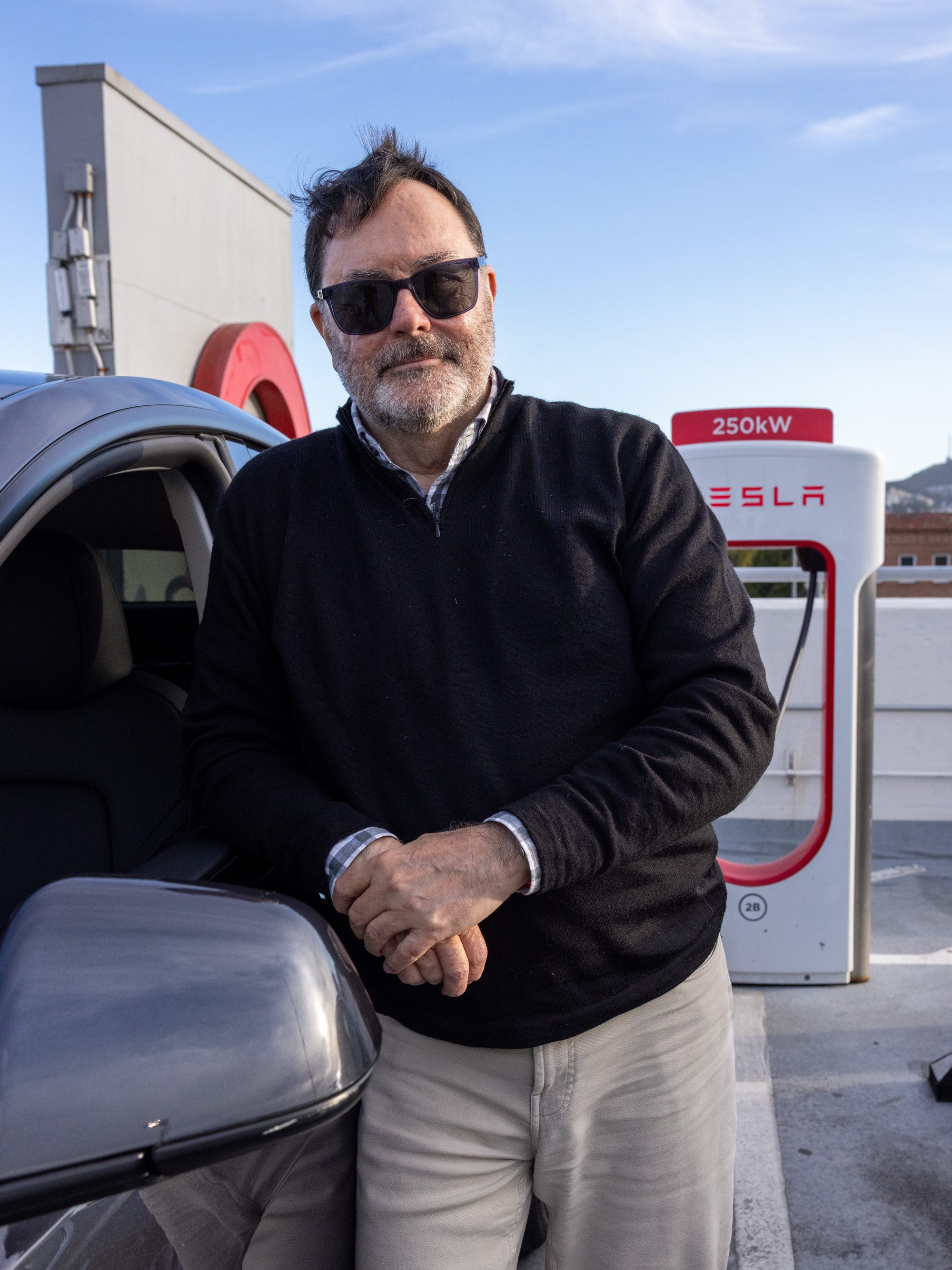 A man standing next to his car