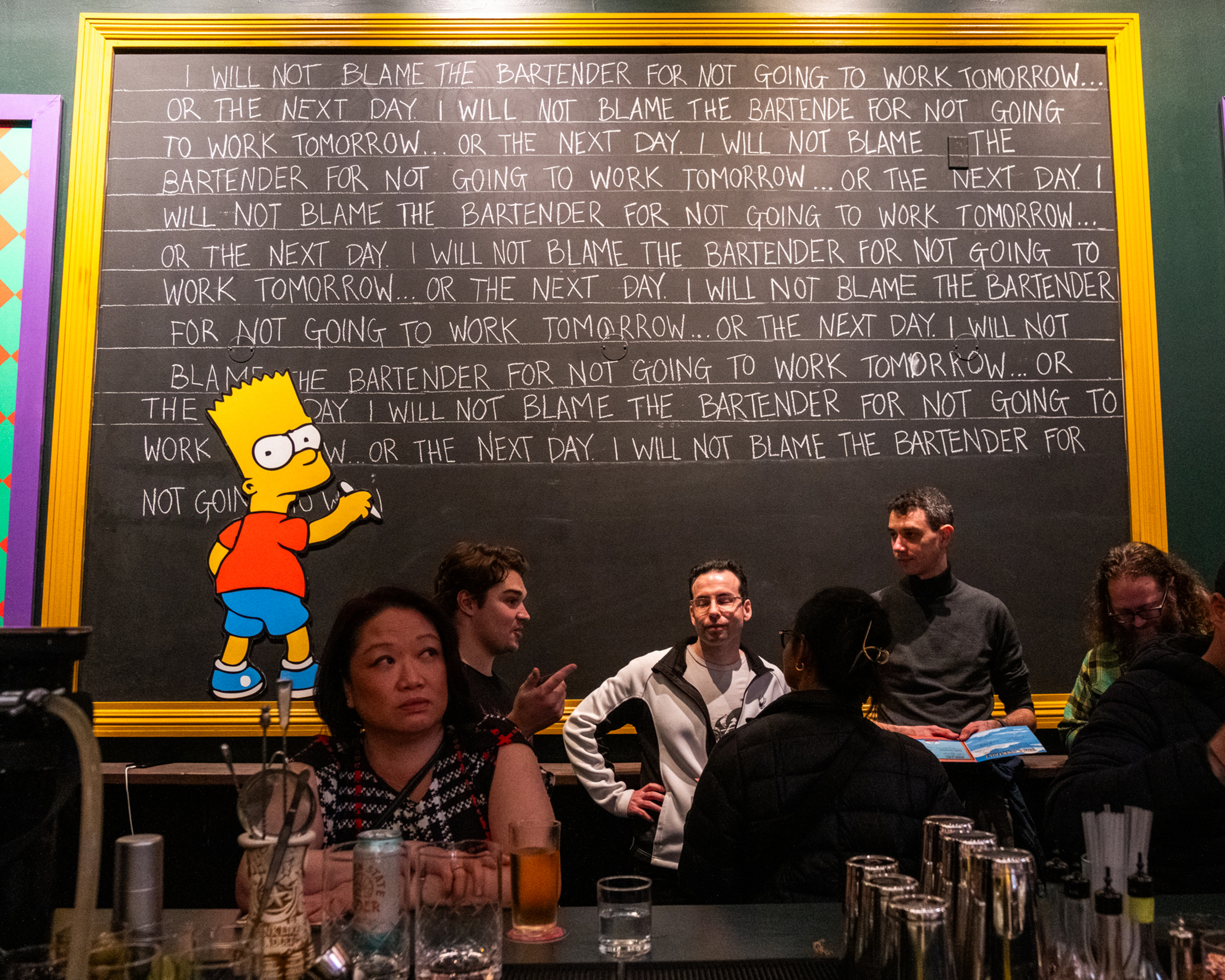 The image shows people at a bar in front of a chalkboard with lines repeatedly stating, &quot;I will not blame the bartender for not going to work tomorrow,&quot; with an animated figure writing.