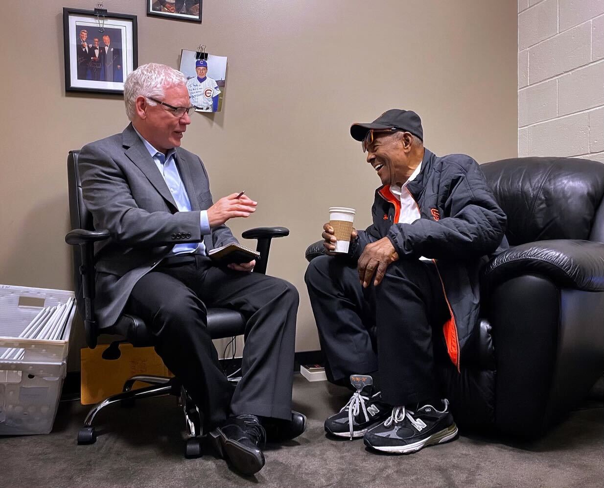 Two men sitting and laughing