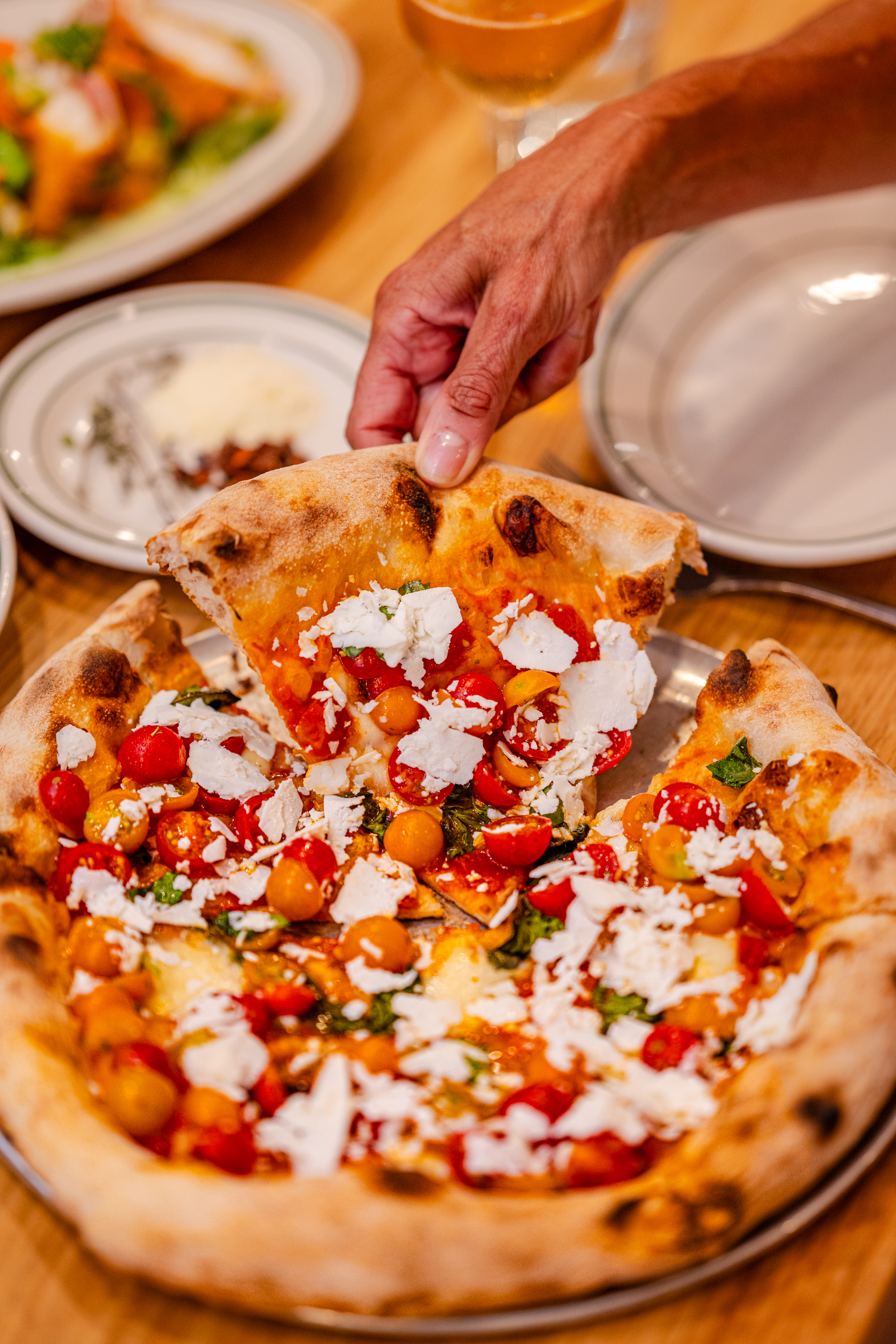 Pizzeria Delfina features seasonal toppings like hen of the woods mushrooms and cherry tomatoes.