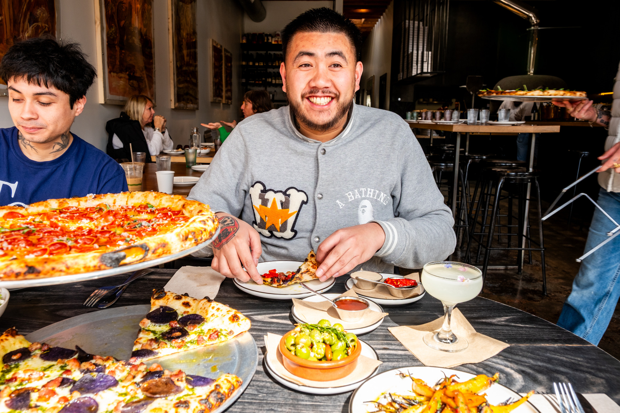 two people eating pizzas