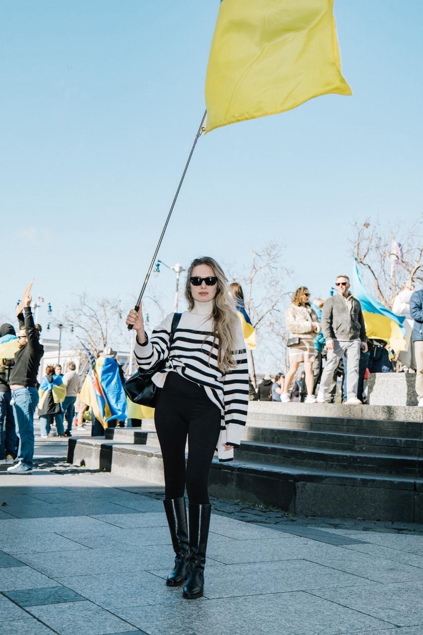 A woman holding a yellow flag