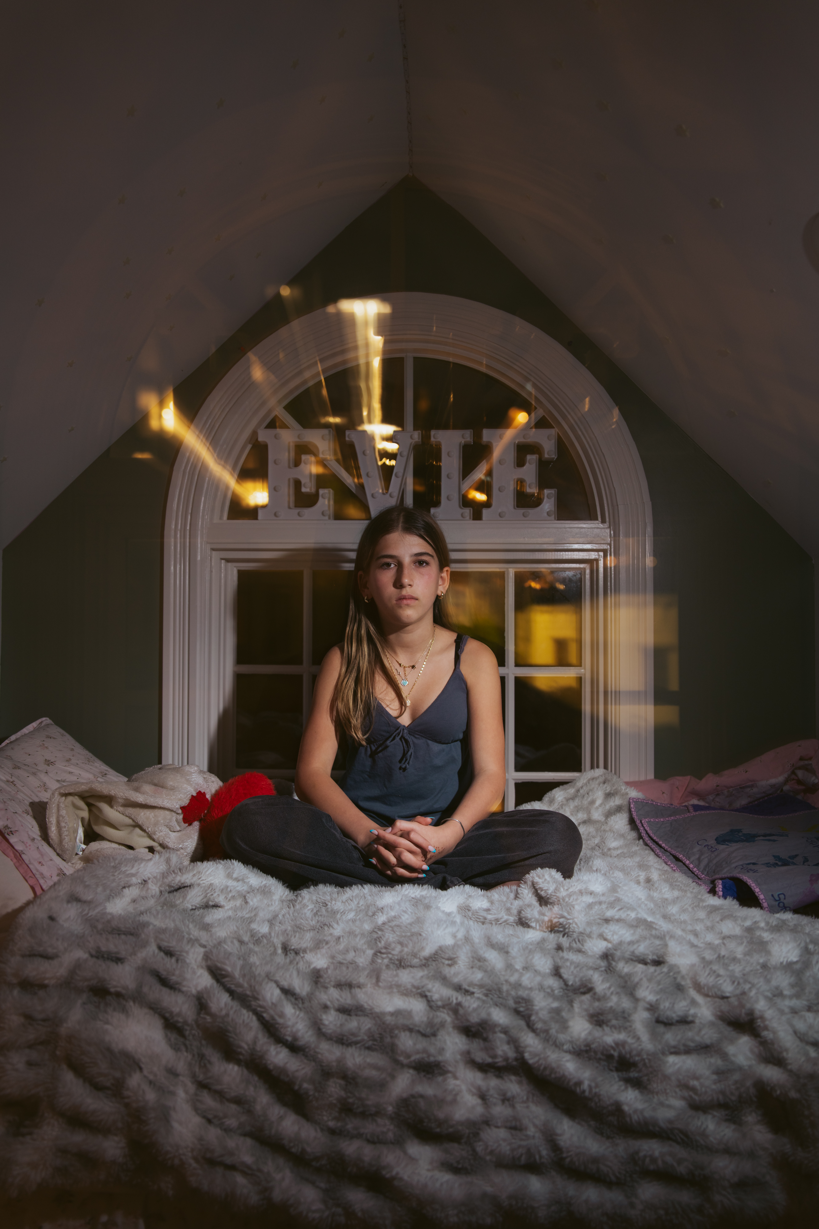 Evening Wiesler sits for a portrait in her bedroom at her home in Bernal Heights on Tuesday, Feb. 18, 2025.   When the Wieslers lost their home in a no-fault furnace fire in 2016, Evening and her older sister Silver were donated empty journals to process their feelings. Evening drew her house in flames, something she never got to witness.  The Wieslers have donated 5000 journals to people in California impacted by fires since they launched their project in 2017.