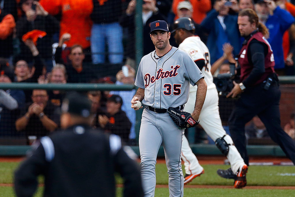 A baseball player in a gray Detroit uniform, number 35, stands on the field holding a ball. The crowd in the background appears to be cheering.