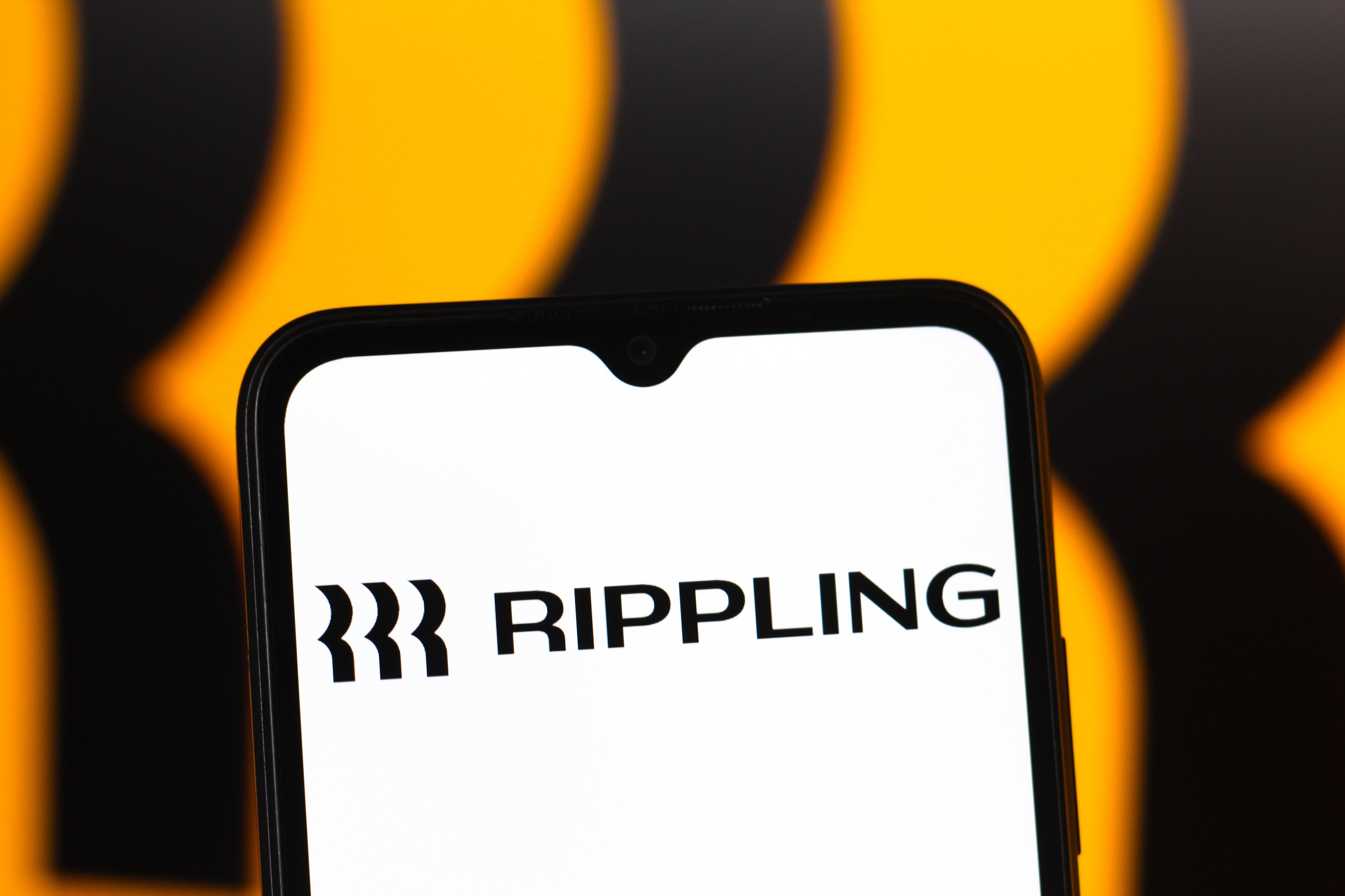 In this photo illustration, the Rippling logo is seen