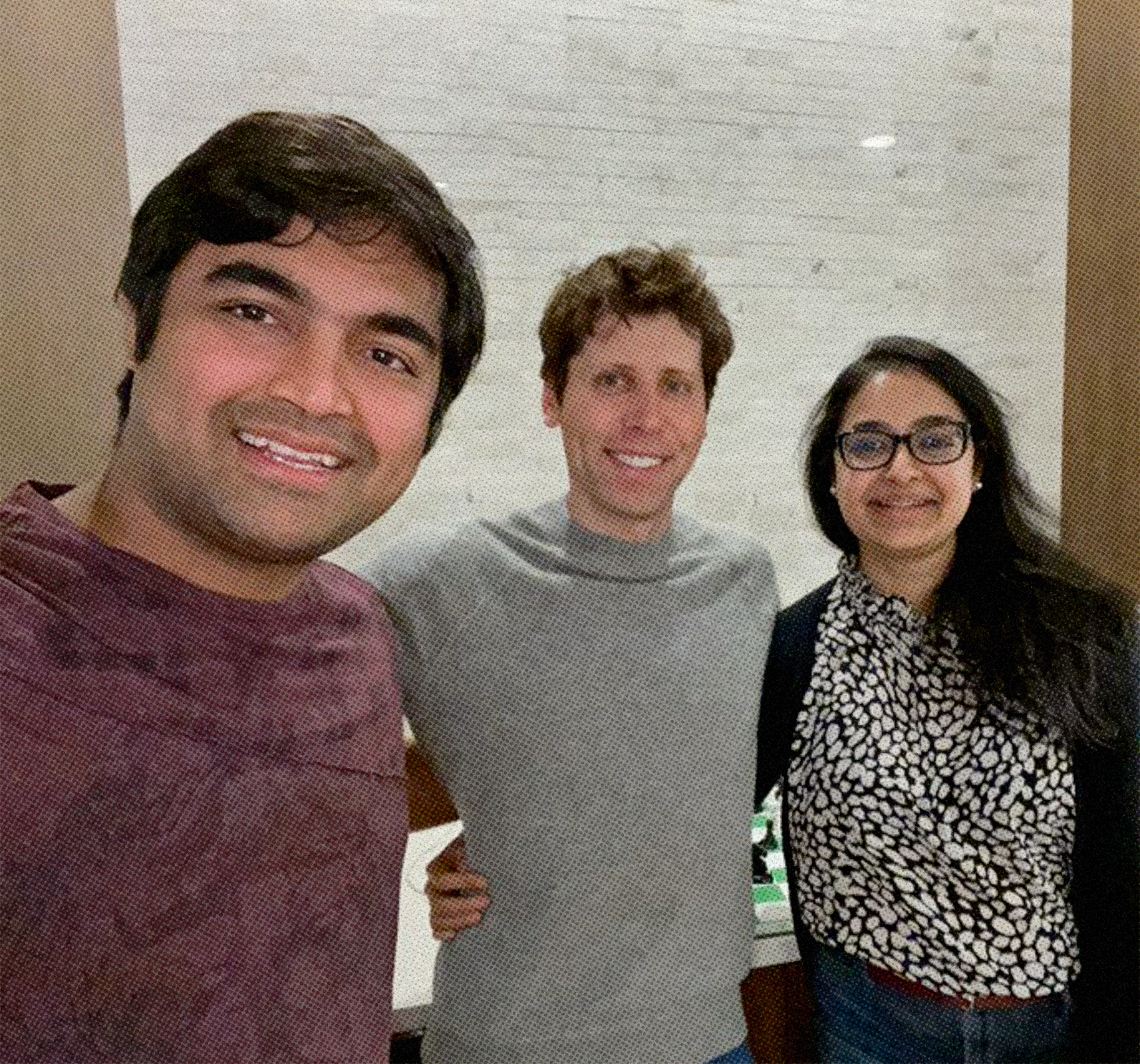 A photo of 3 people smiling at the camera