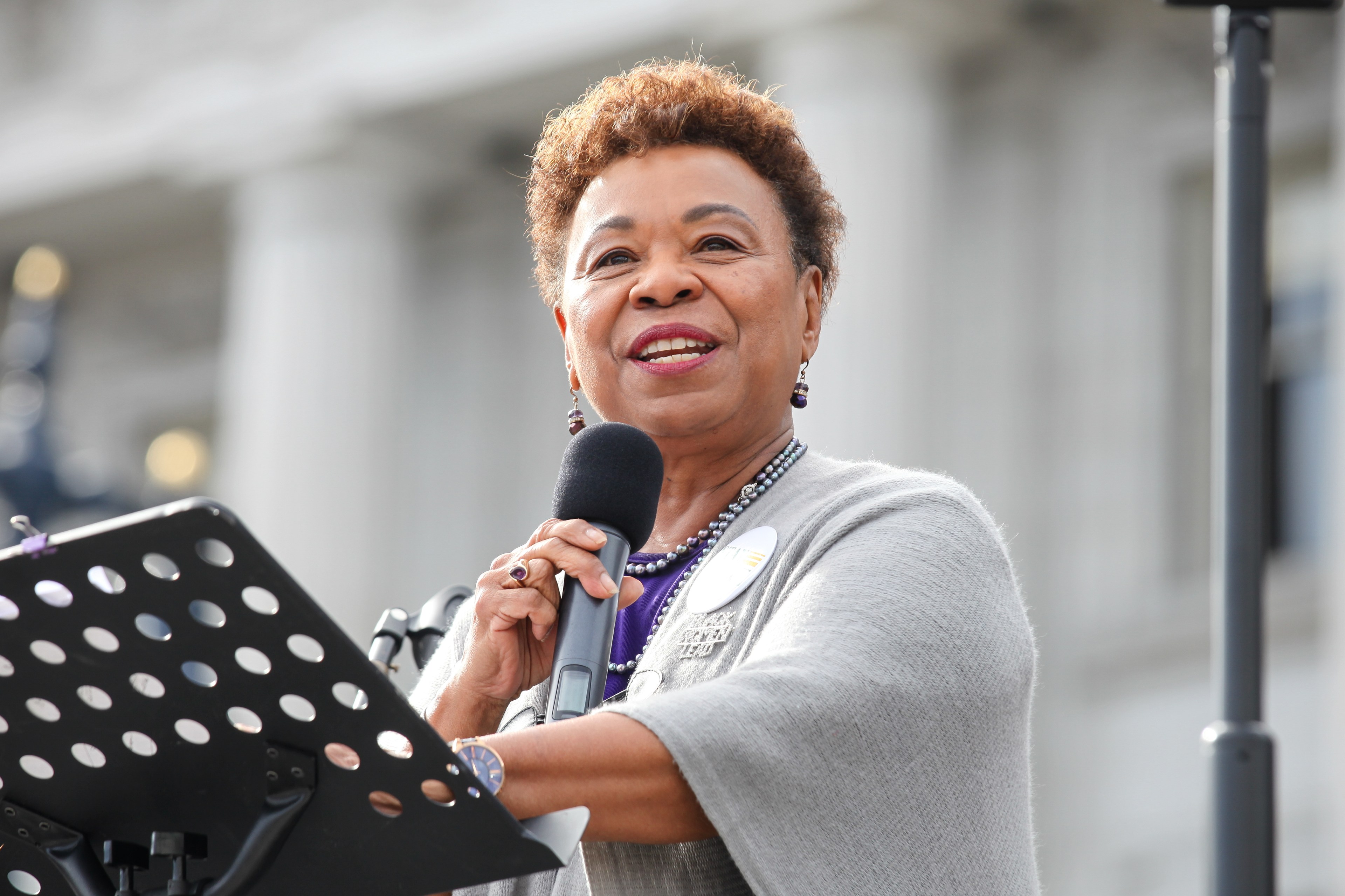 A photo of a female politician talking at a podium