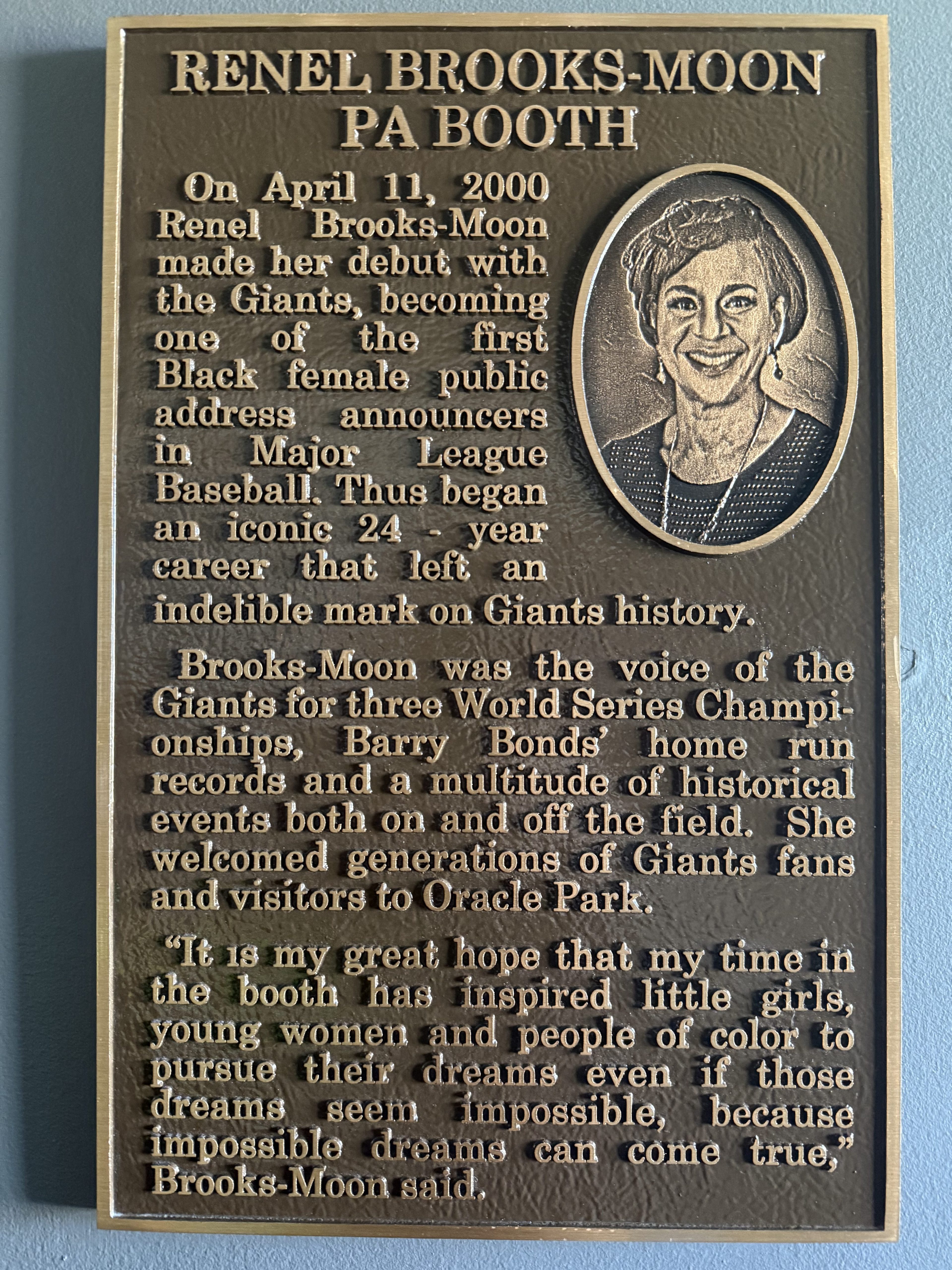 This plaque honors Renel Brooks-Moon, a pioneering Black female MLB announcer for the Giants, celebrating her 24-year career and inspiring future generations.