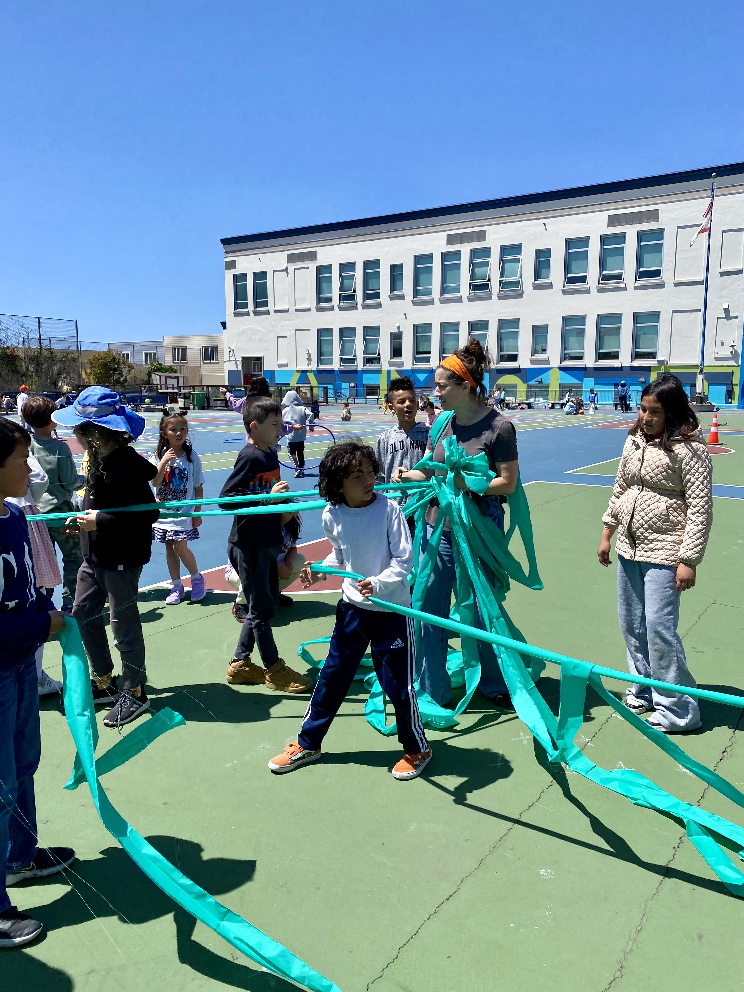A photo of community members decorating a fence.
