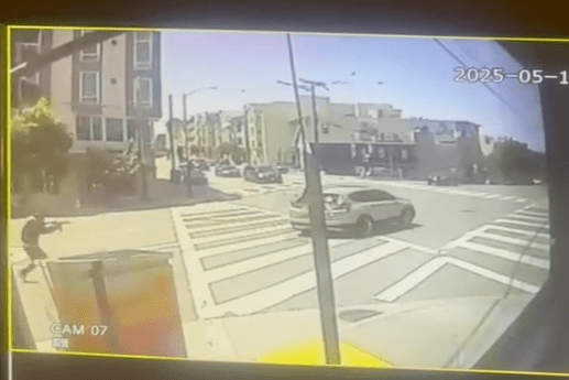 A city intersection with crosswalks is shown on a sunny day. Cars are visible on the street, and a pedestrian stands on the sidewalk. The date reads 2025-05-14.