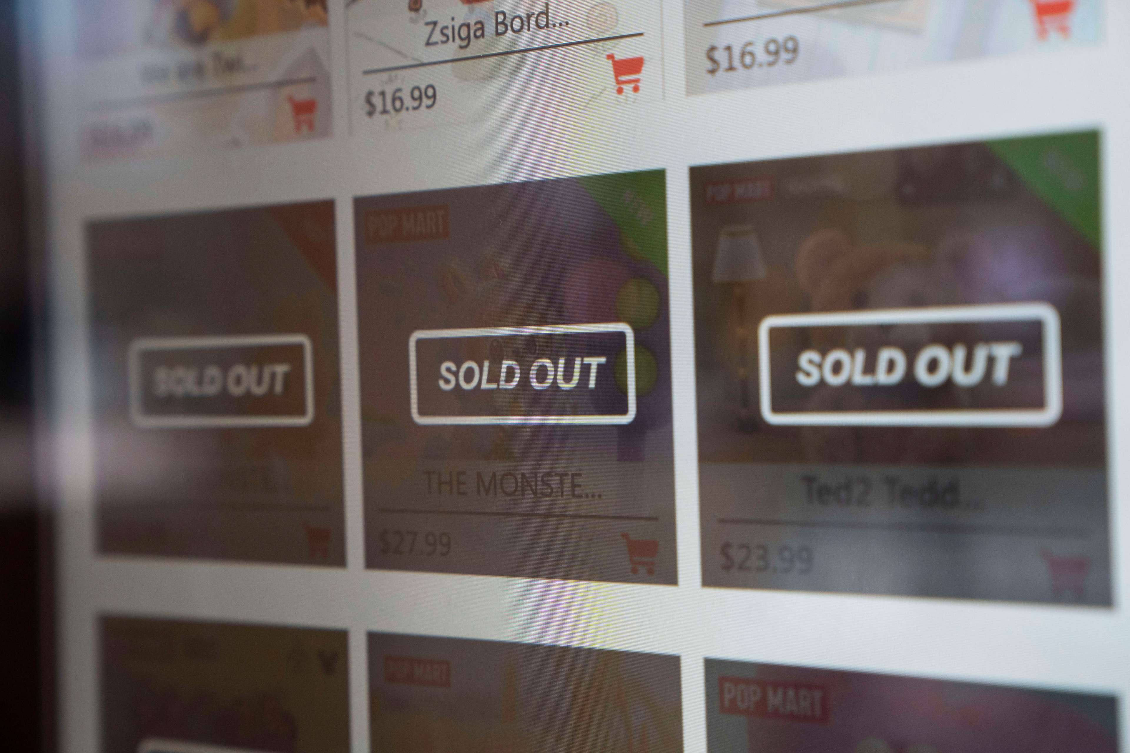 The image shows a webpage with several products listed, each marked &quot;Sold Out.&quot; Prices are visible, and there's a shopping cart icon next to each item.