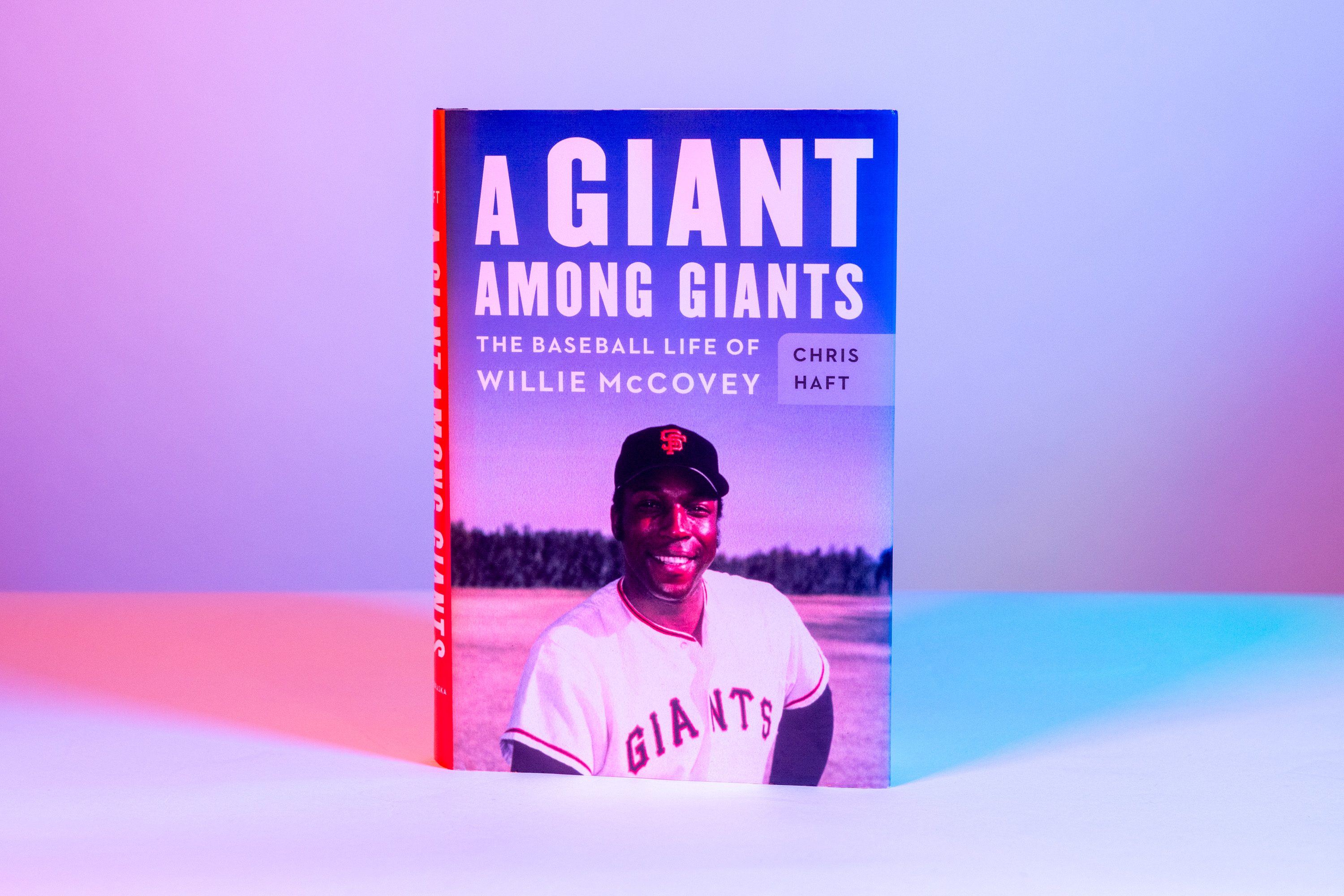 The image shows a book titled "A Giant Among Giants: The Baseball Life of Willie McCovey" by Chris Haft. It features a photo of McCovey in a Giants uniform.