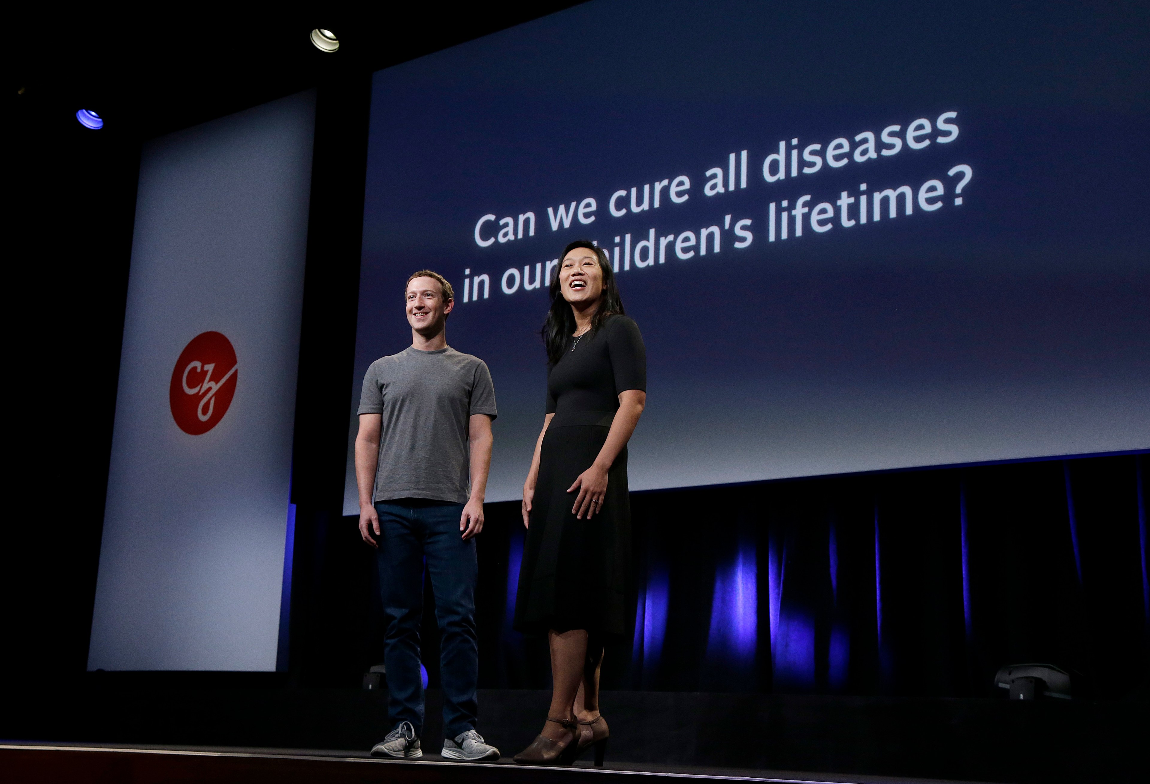 In this Tuesday, Sept. 20, 2016, photo, Facebook CEO Mark Zuckerberg and his wife, Priscilla Chan, prepare for a speech in San Francisco. Zuckerberg and Chan have a new lofty goal: to cure, manage or eradicate all disease by the end of this century. To this end, the Chan Zuckerberg Initiative, the couple's philanthropic organization, is committing significant financial resources over the next decade to help accelerate basic science research. (AP Photo/Jeff Chiu)