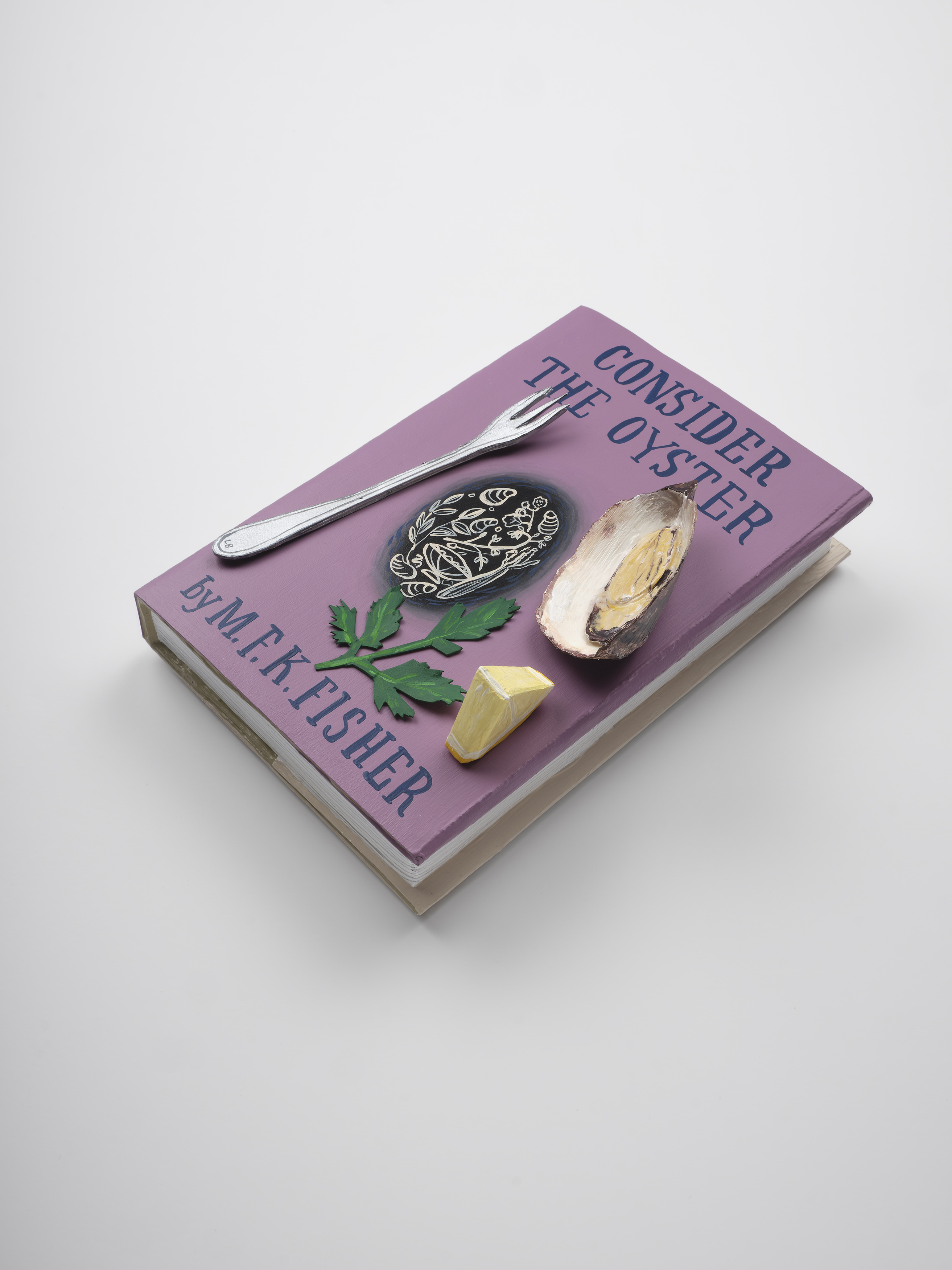 A purple book titled &quot;Consider the Oyster&quot; by M.F.K. Fisher displays an oyster shell, a small fork, a piece of lemon, and parsley on its cover.