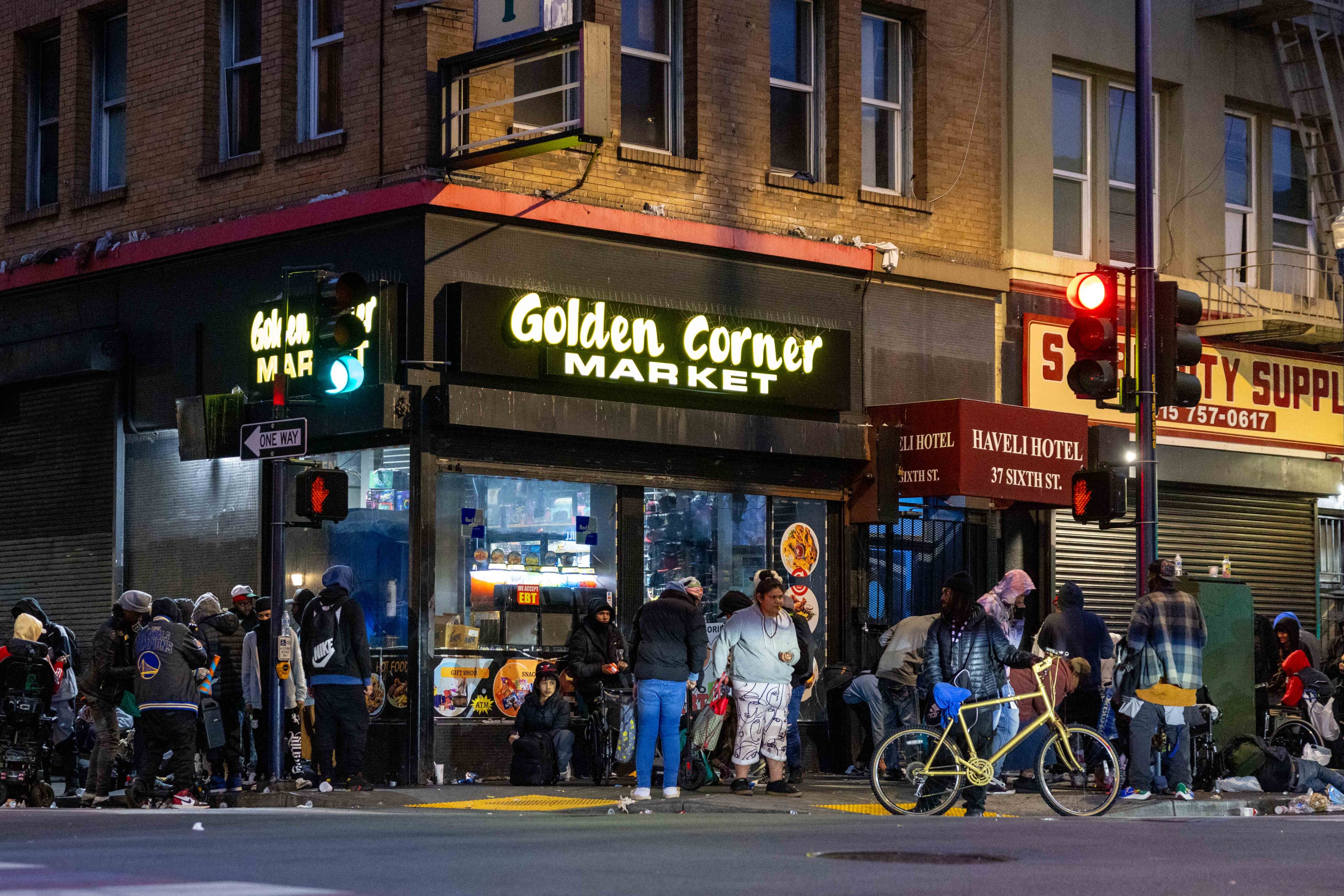 The image shows a bustling urban corner with people gathered outside the "Golden Corner Market" beneath bright signage, along a street lined with other businesses.