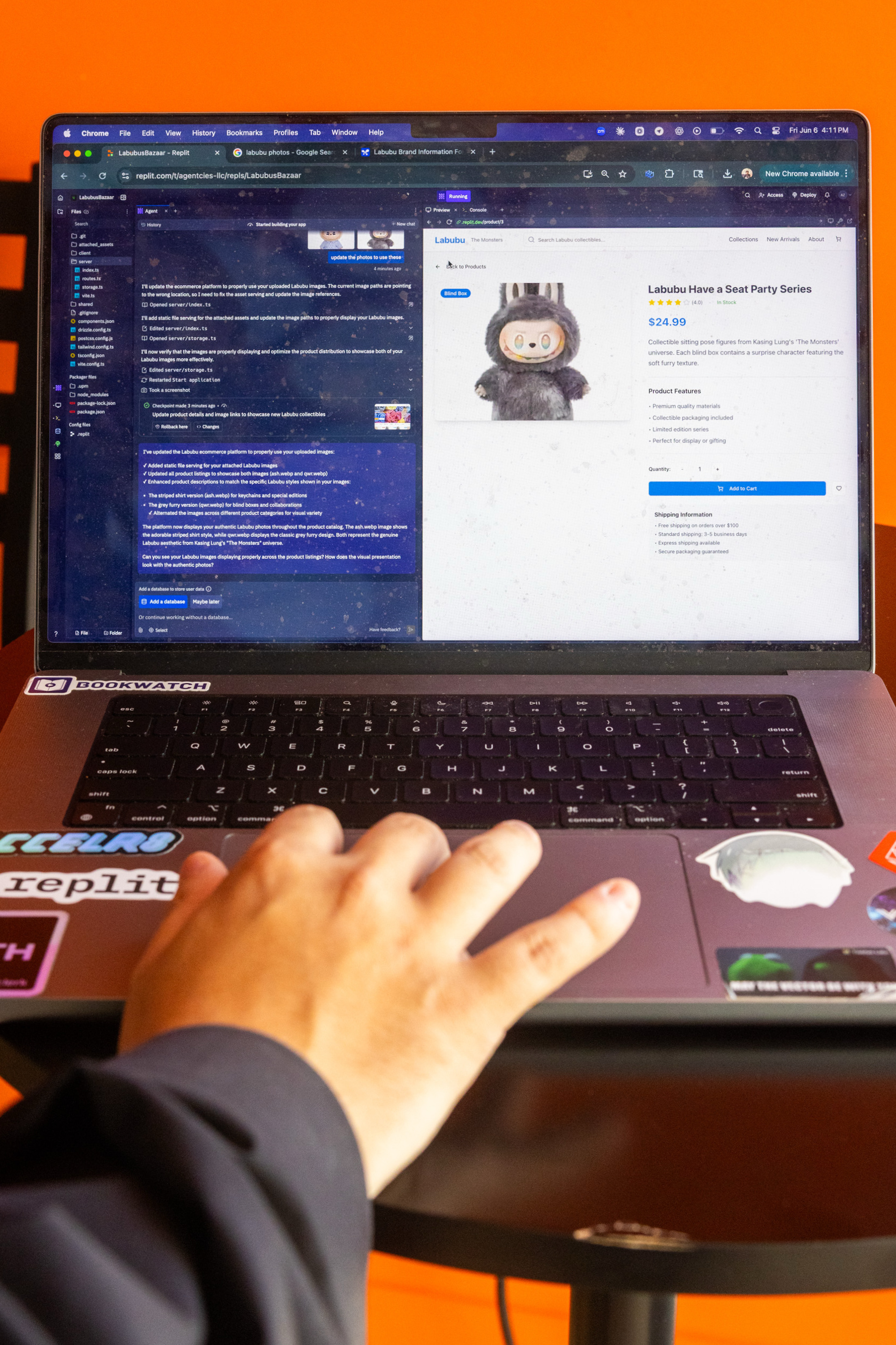 A person uses a laptop displaying a webpage with a toy figure for sale. The laptop's lid has several stickers, and there's an orange background.