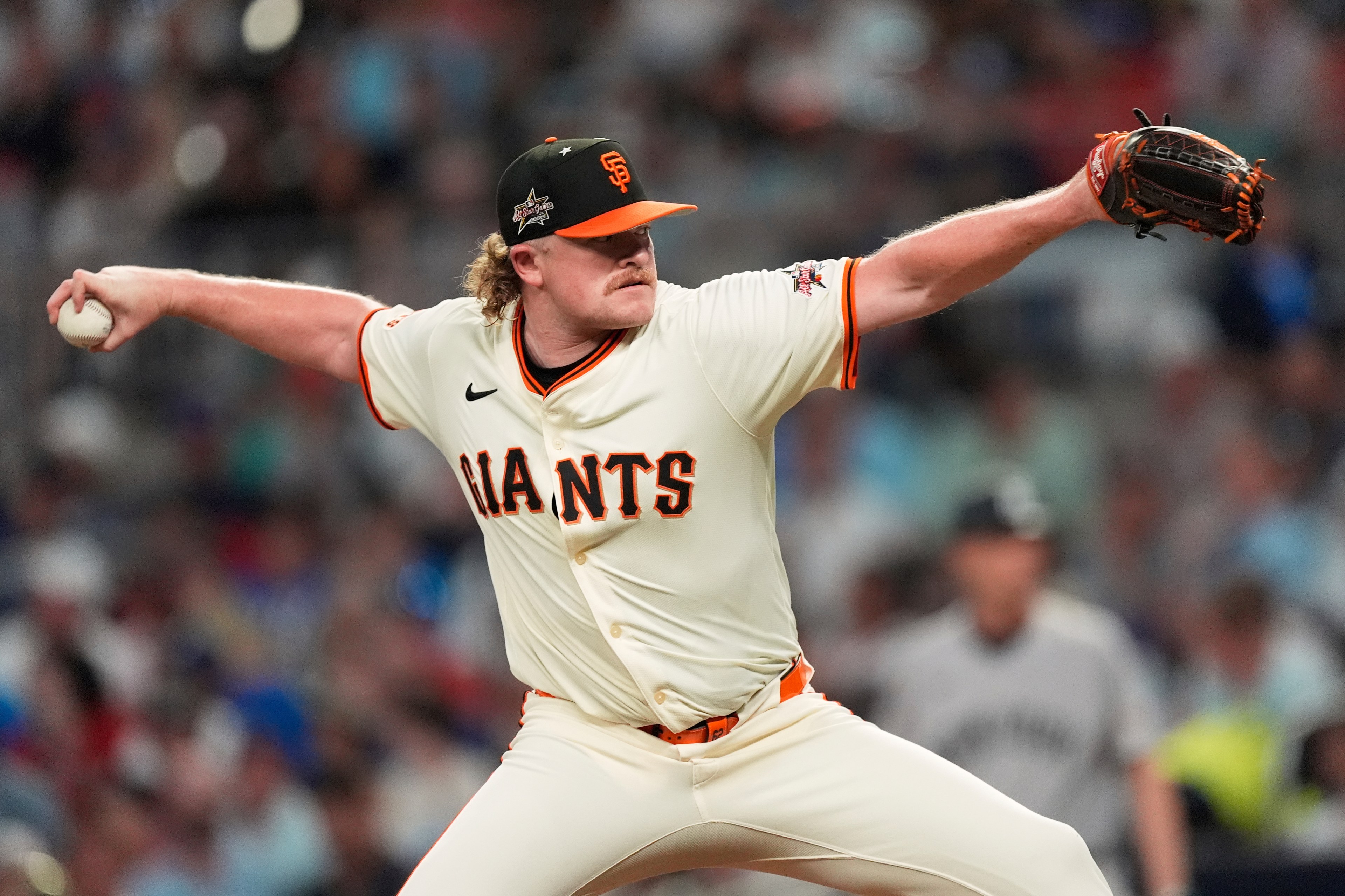 A baseball player in a San Francisco Giants uniform is pitching. He is mid-motion, with one arm extended forward holding the ball and the other arm back, glove in hand.